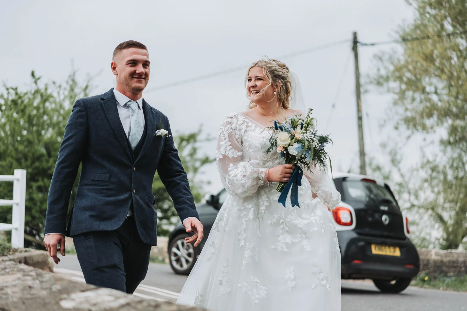 bride-and-groom-walking-over-oxfordshire-bridge.jpg