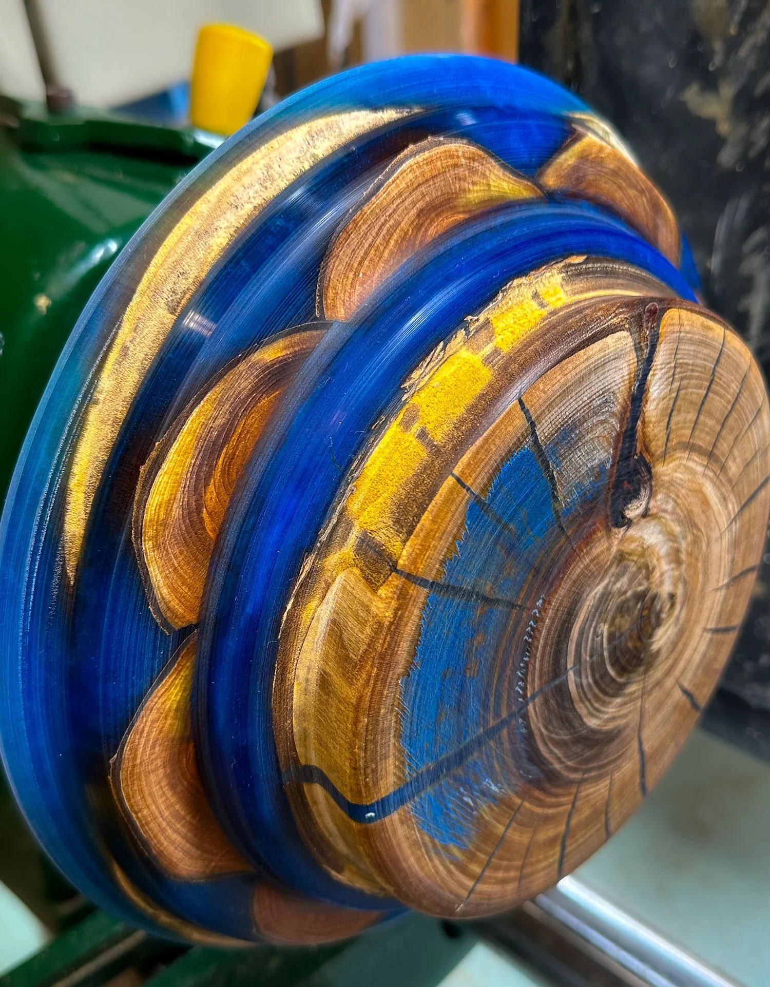  Half way through turning a bowl made from several layers of cherry wood and coloured epoxy resin.  