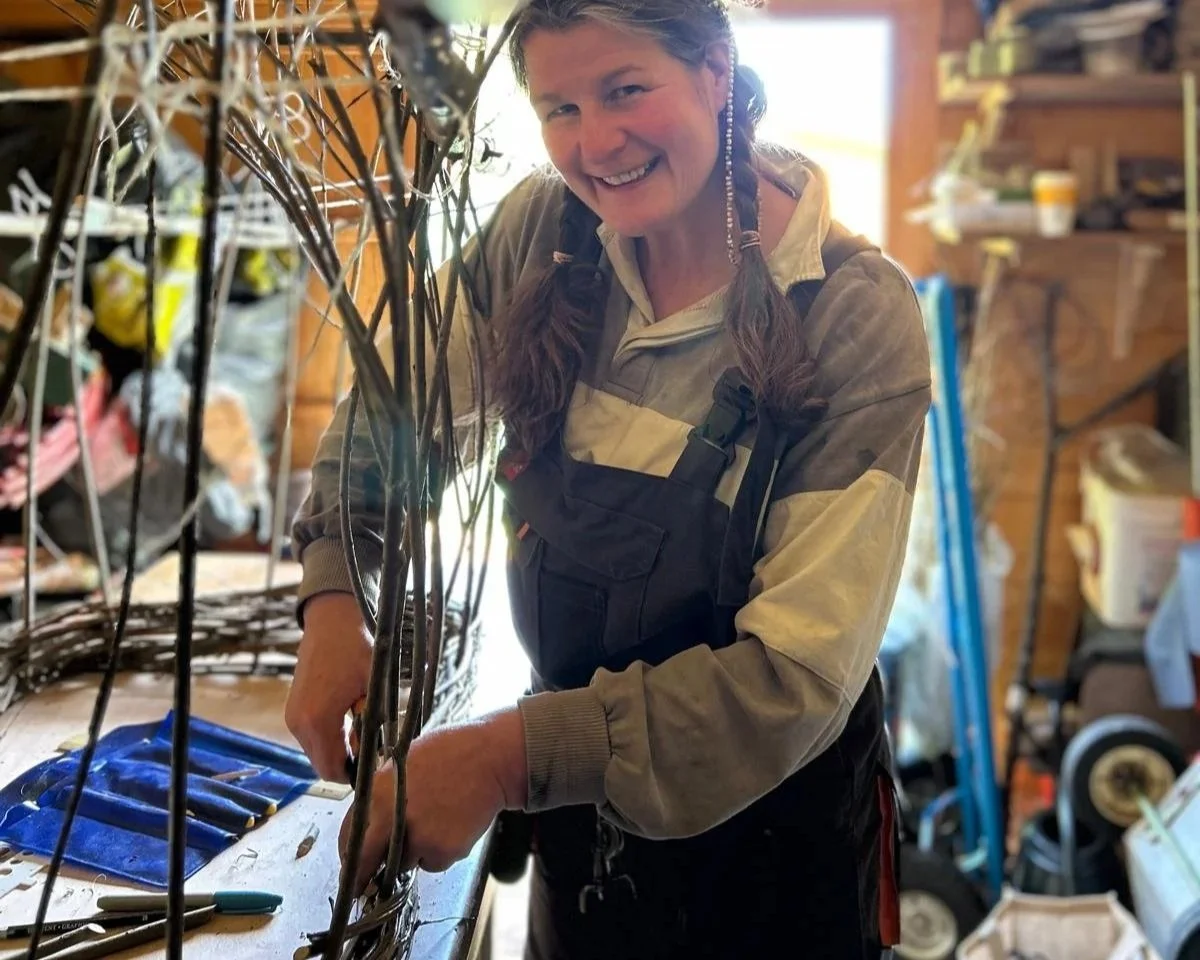 Woman making a coffin in a workshop