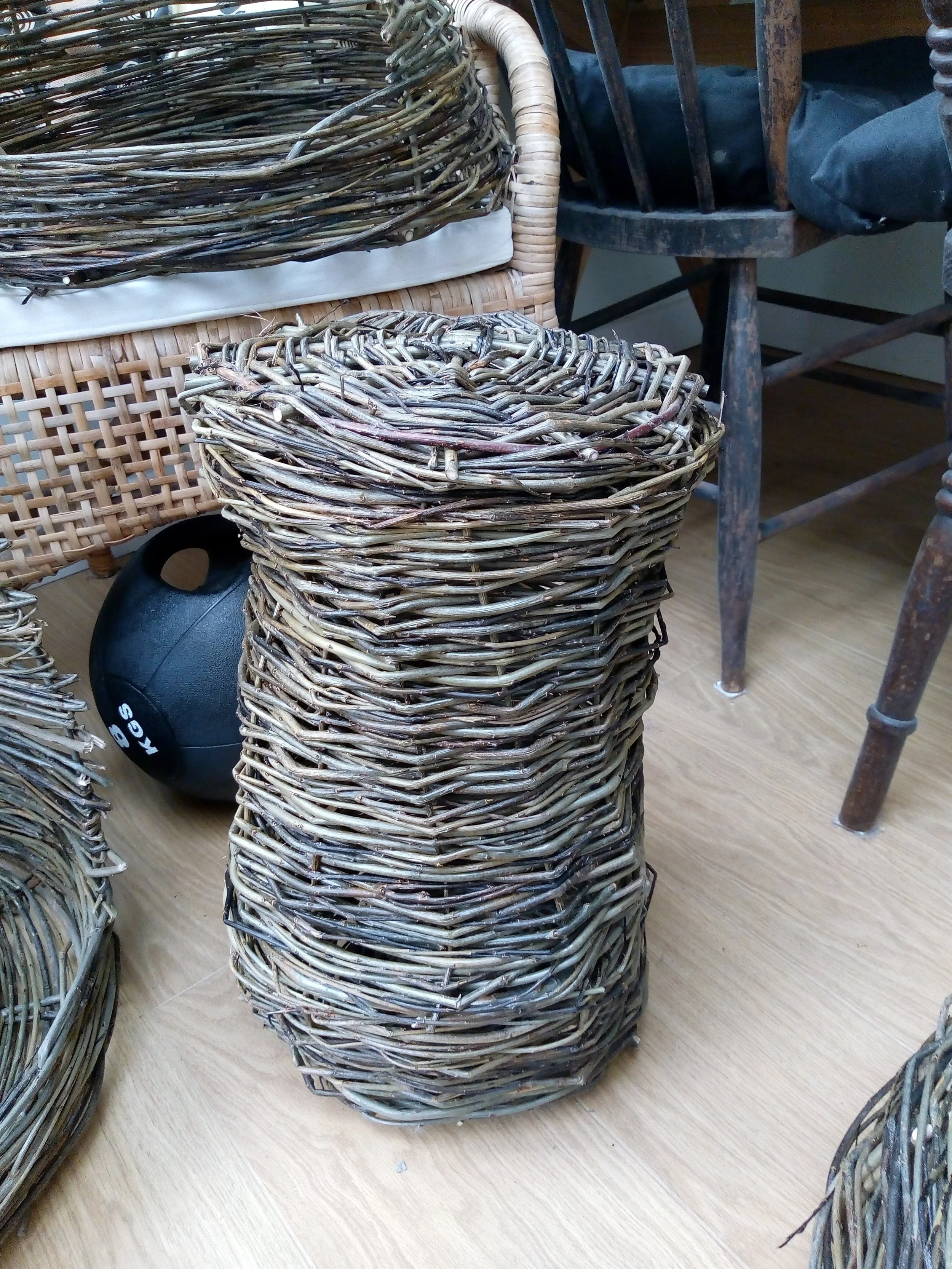 A woven willow wicker toilet roll holder basket created by awaywithwillow.com