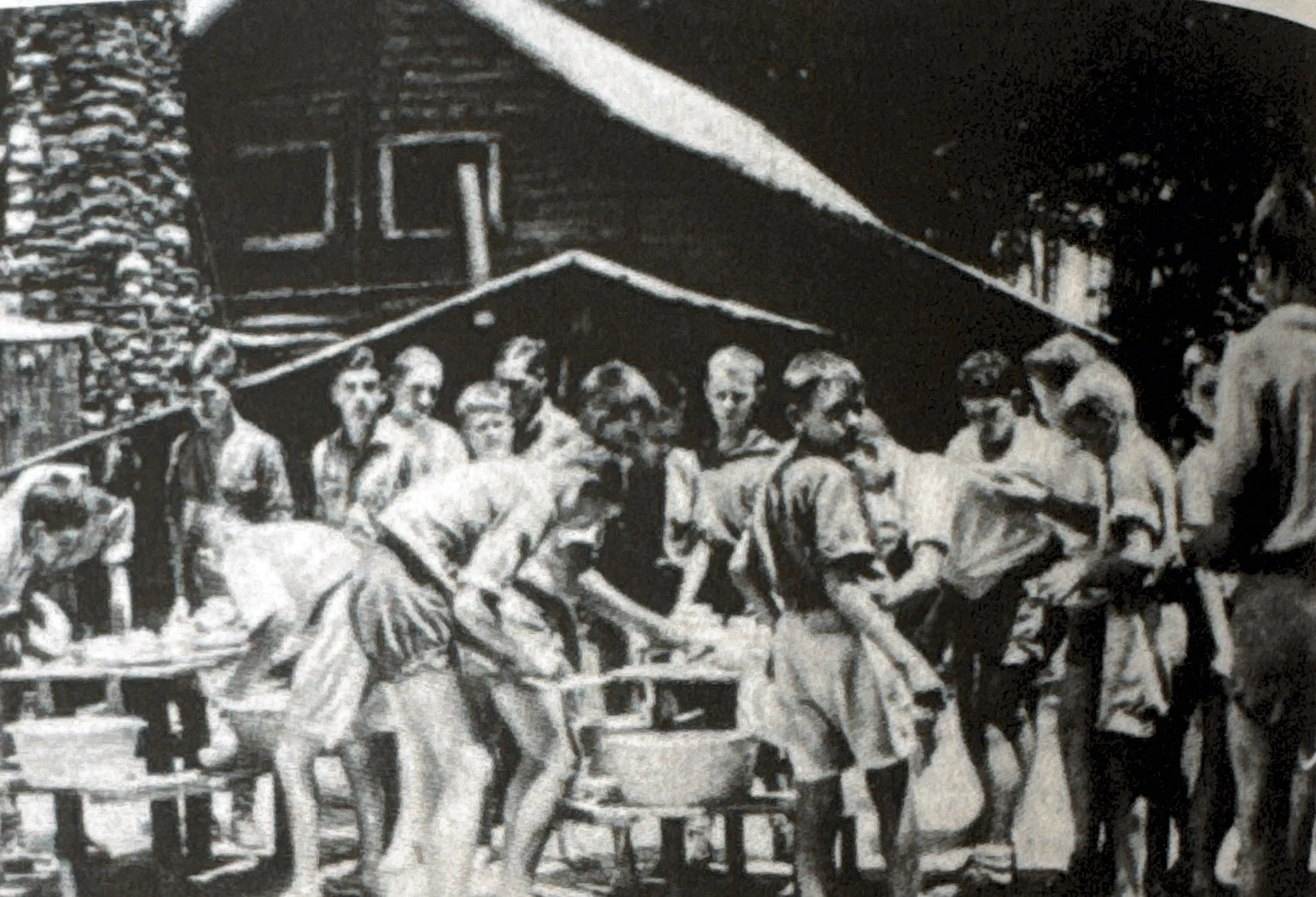Scouts washing dishes after a meal, 1930s