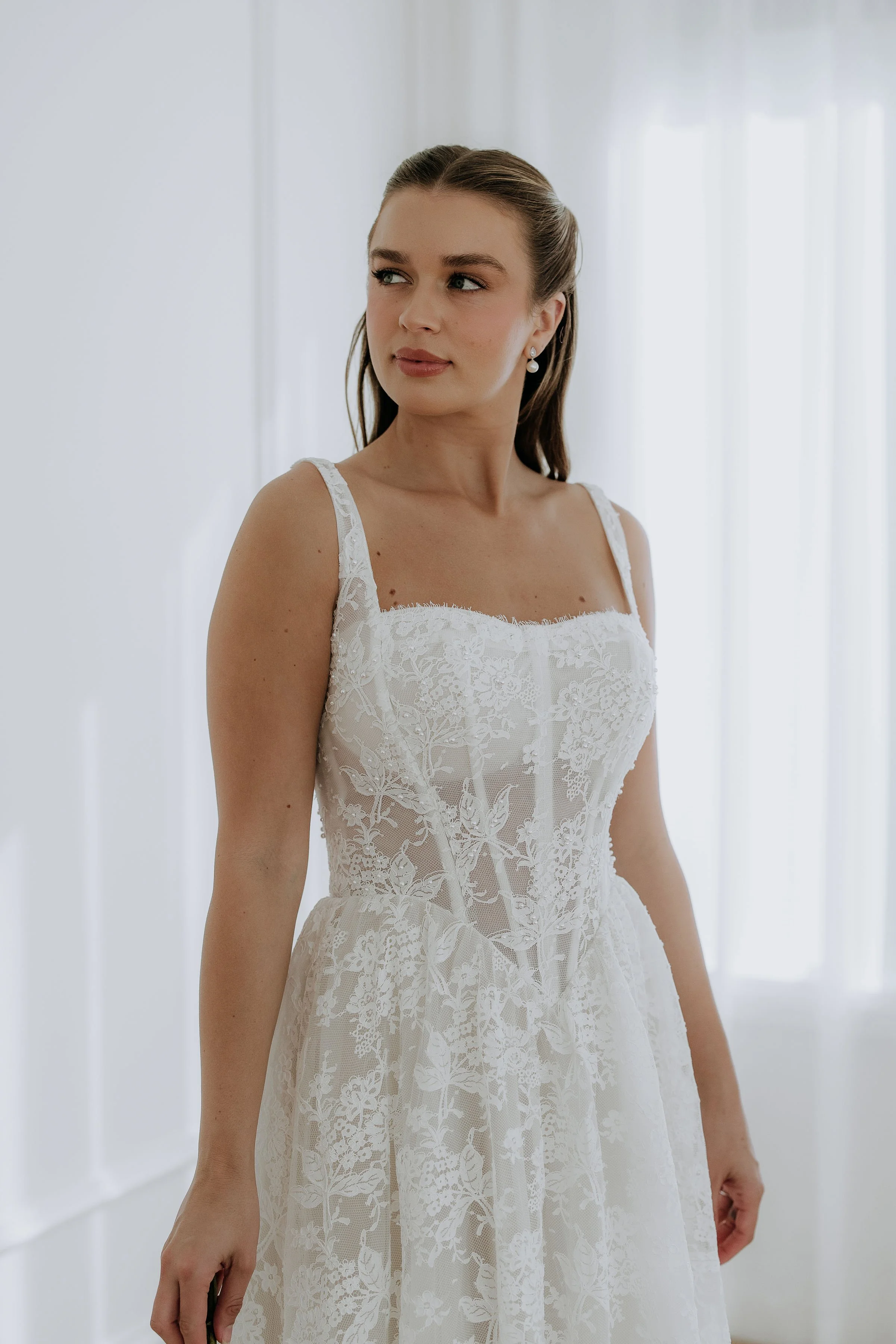 Close up view of the Elle dress by Kelly Lin. Wide straps and a flattering Basque waist. 