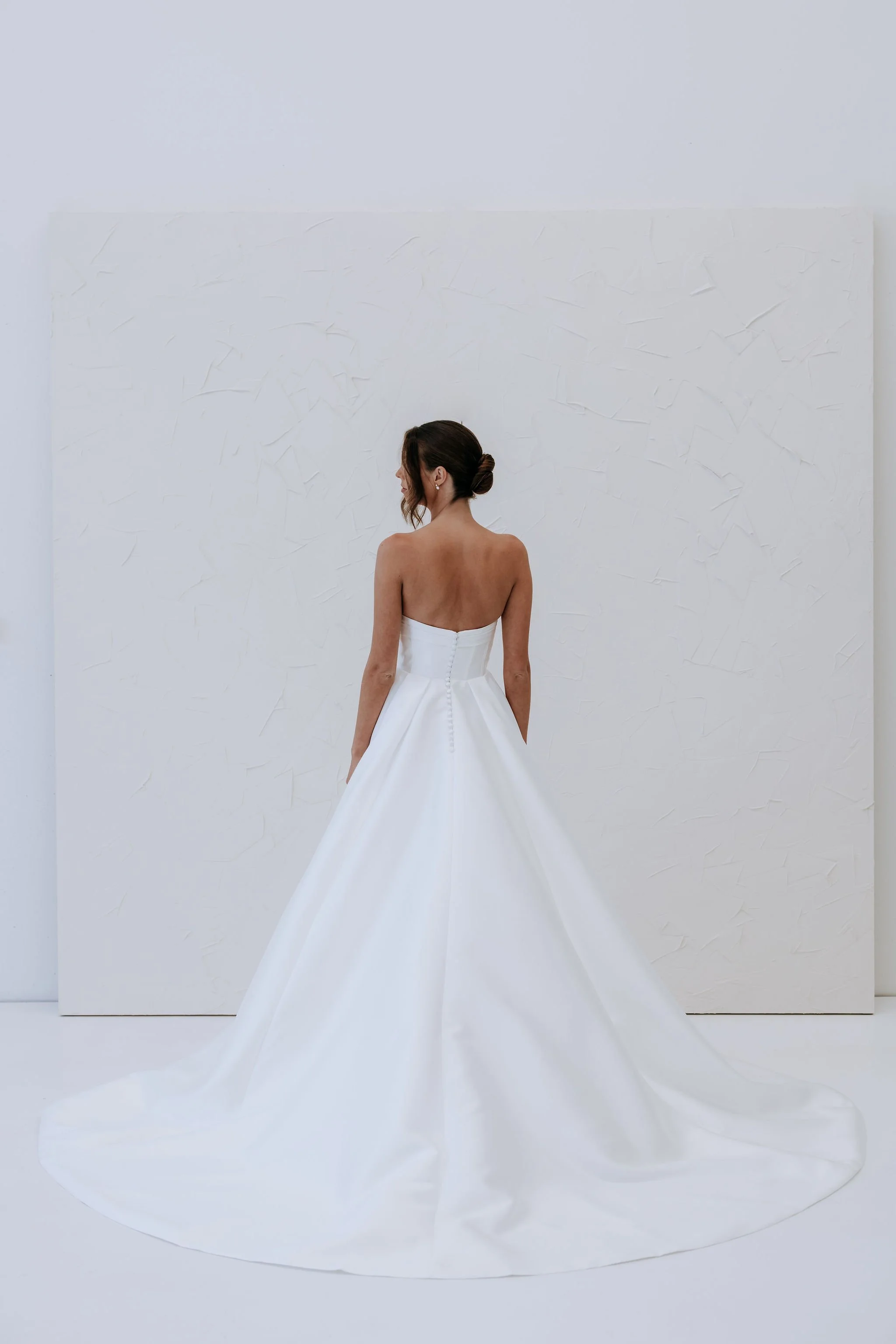 The Abbey Dress by Kelly Lin is a Modern strapless gown made from Elegant Mikado fabric. Available to try at our Salisbury Wedding Dress Shop.