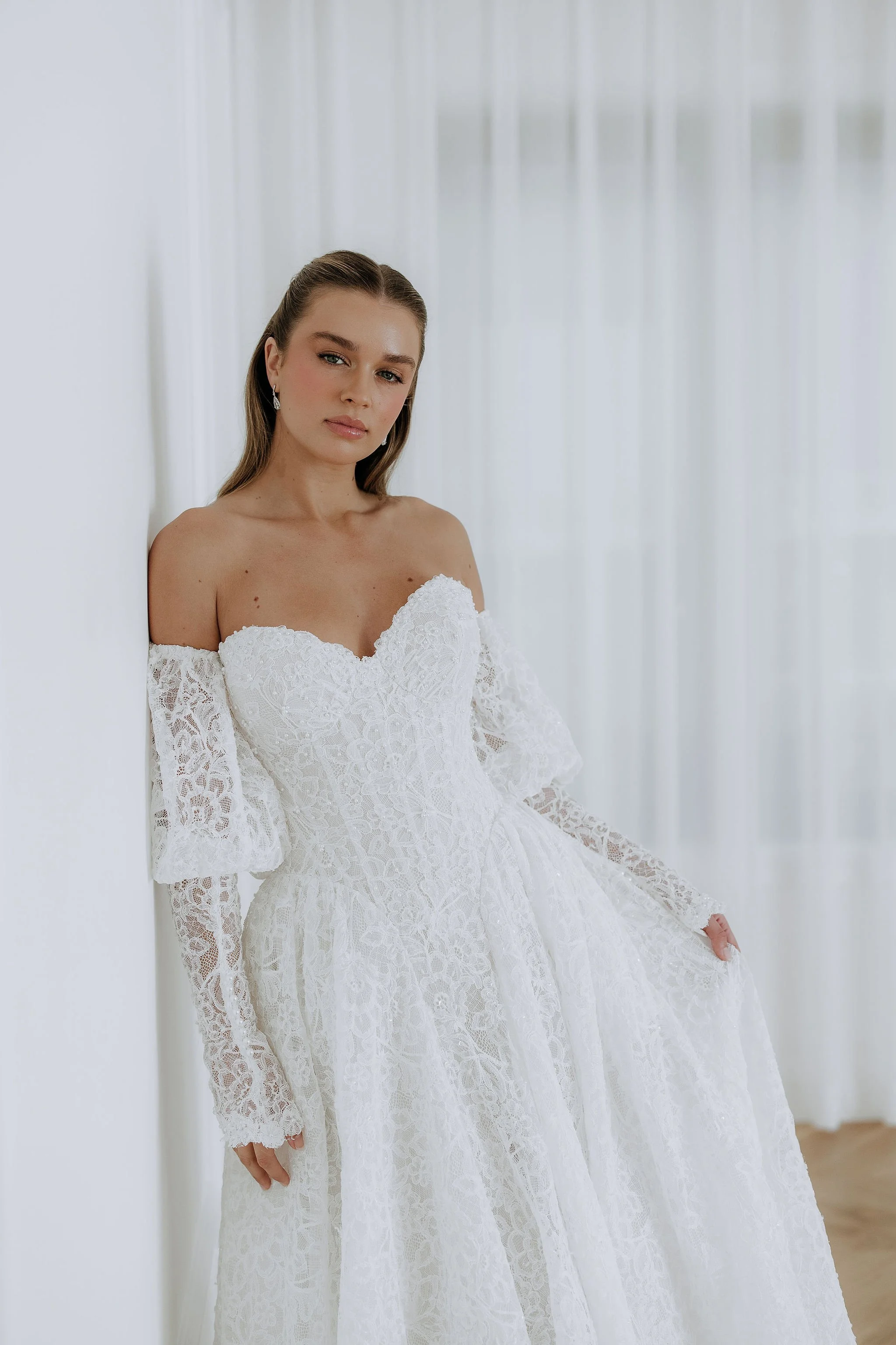 Lottie is a full lace strapless wedding dress with detachable sleeves. By Kelly Lin Couture. 