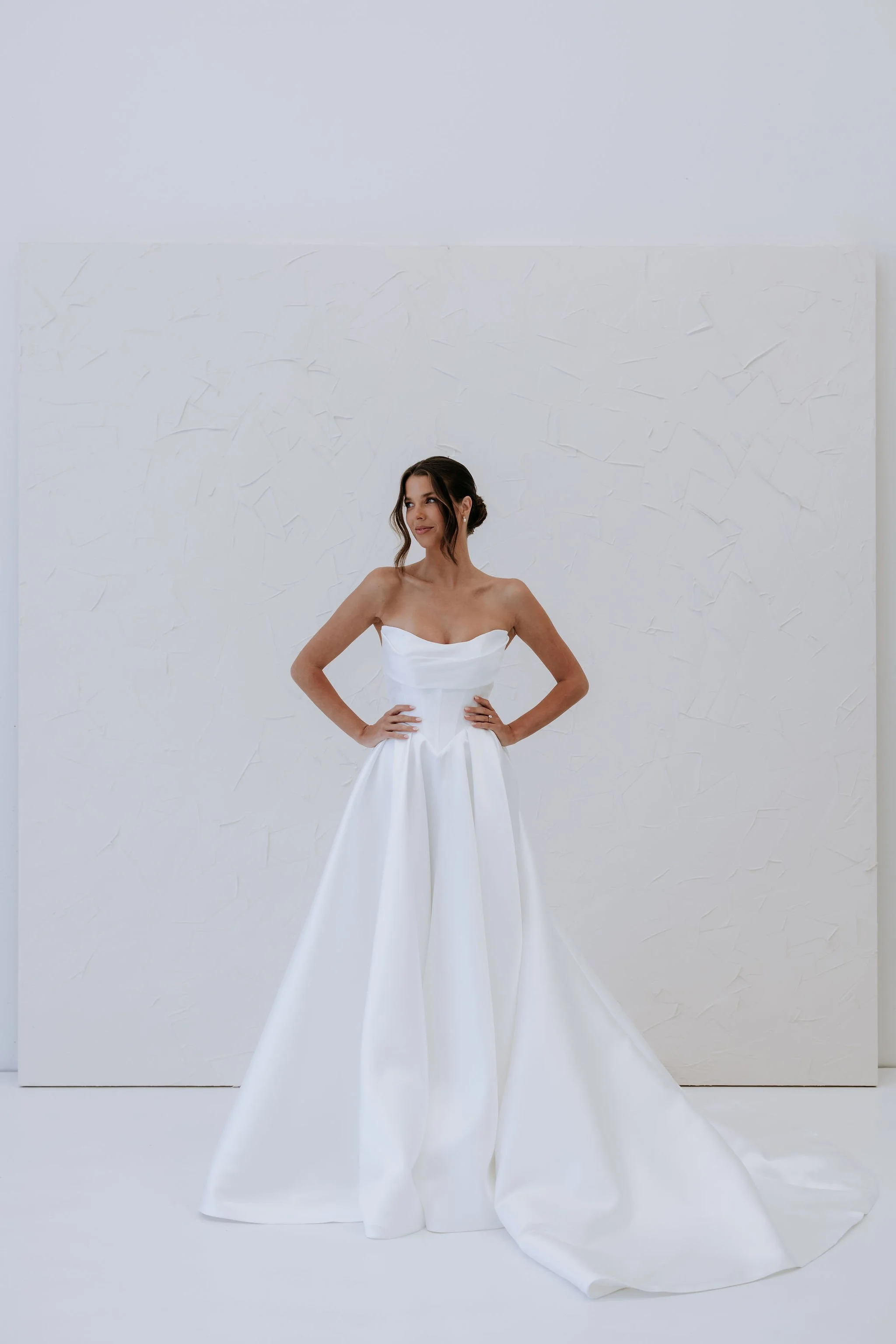 Kelly Lin's Abbey Dress is a strapless gown made from Mikado with a Basque waist. Available to try at our Salisbury Wedding Dress Shop.