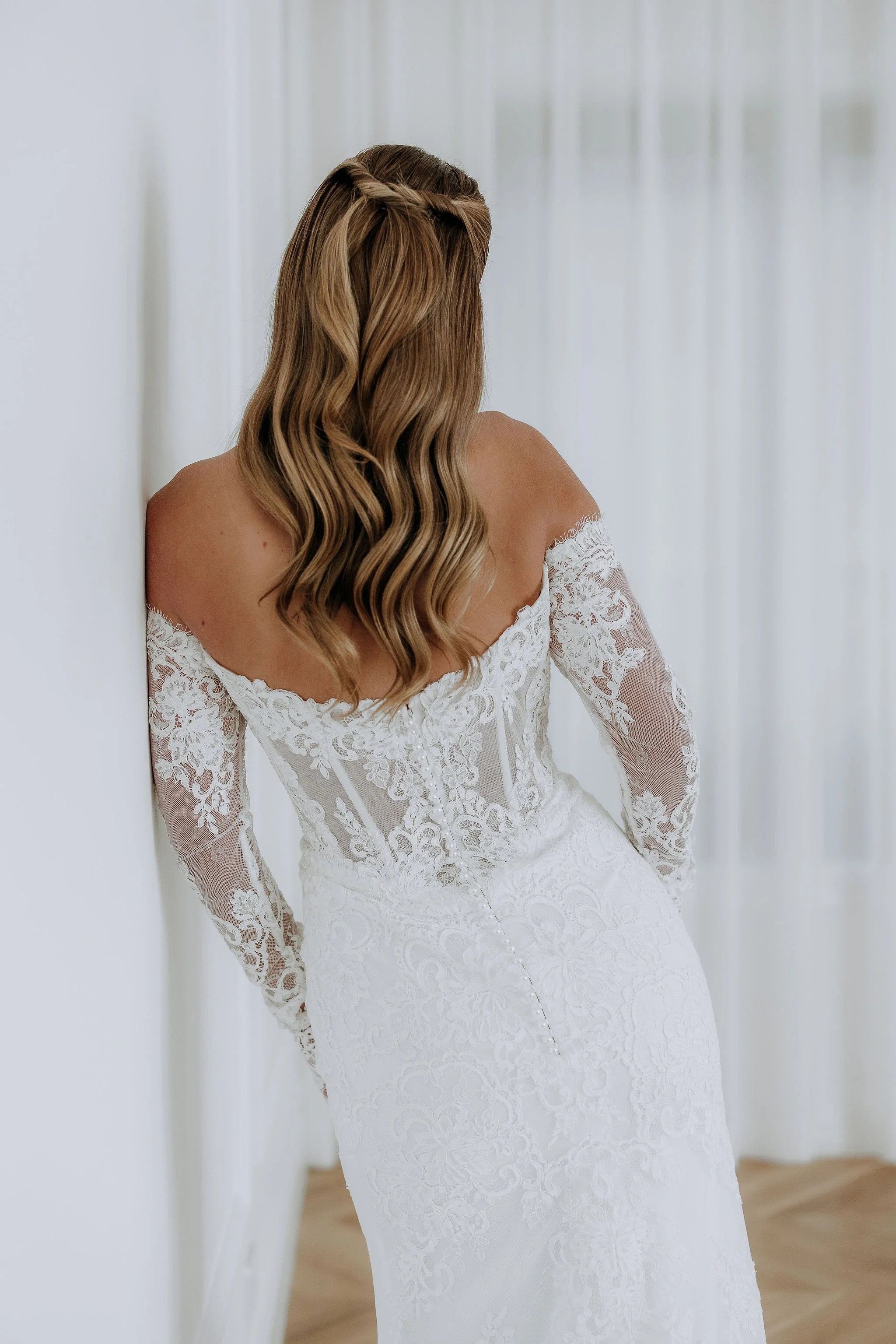 Mimi by Australian Designer Kelly Lin. Elegant fitted lace dress with detachable full length lace sleeves. Available at our Salisbury wedding dress studio.