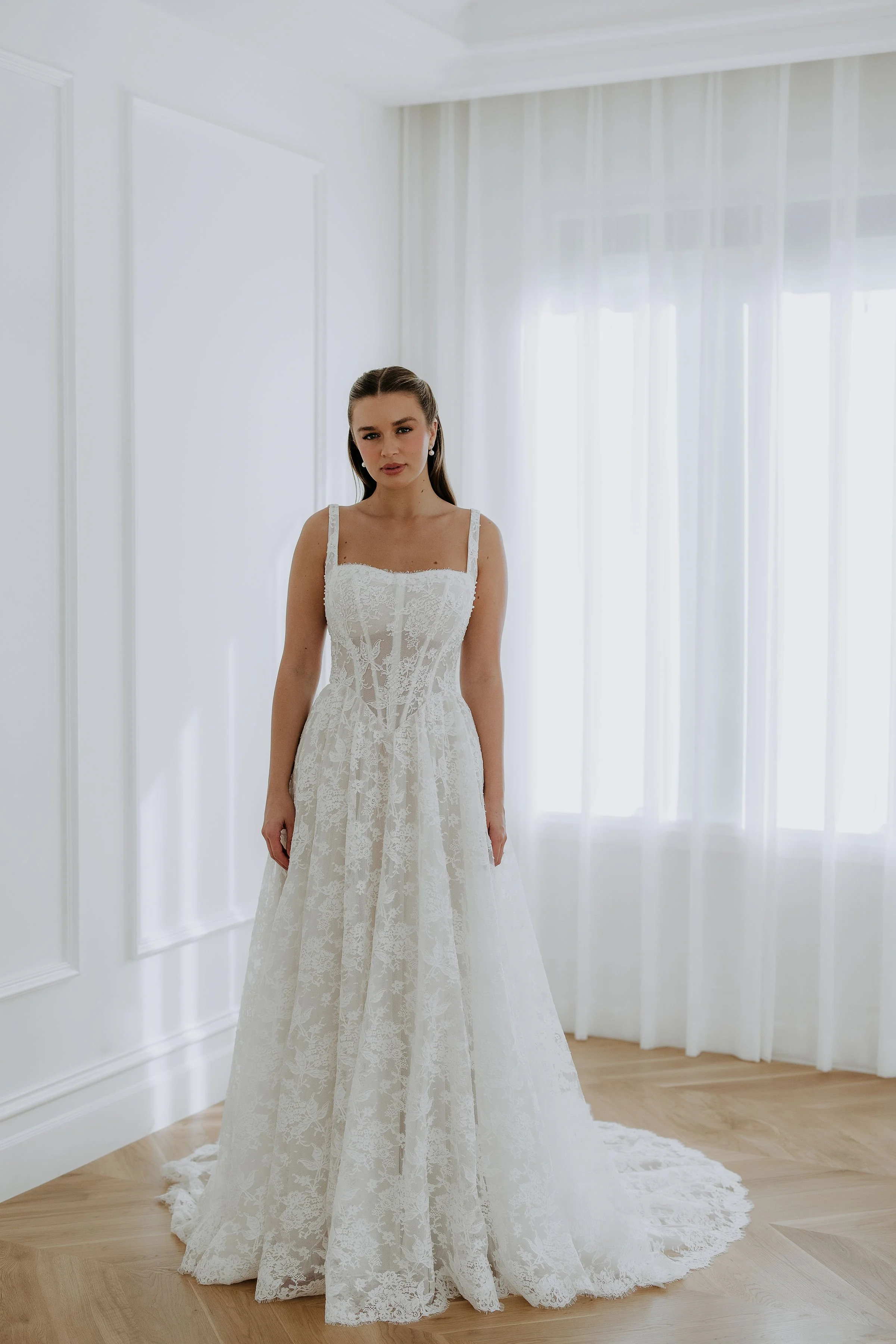 Elle by Kelly Lin is a full lace A line dress with straps and sweetheart neckline. Available in Salisbury.