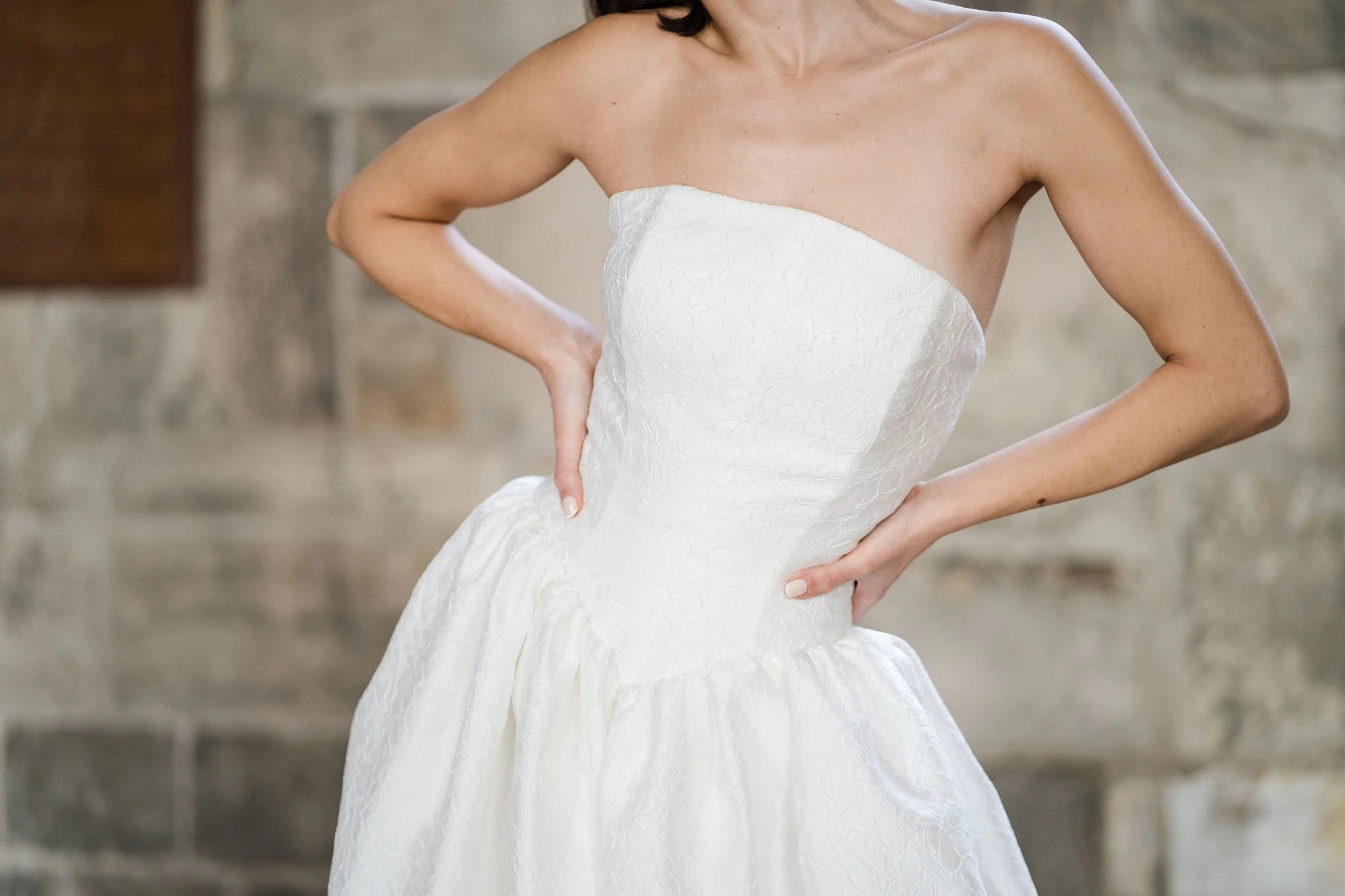 Titania Dress by Rolling in Roses – contemporary bridal gown inspired by Shakespeare's era, featuring a dropped waistline, sculptural tulip-shaped skirt with hidden pockets, and traditional corsetry techniques using high-quality sprung boning, crafte