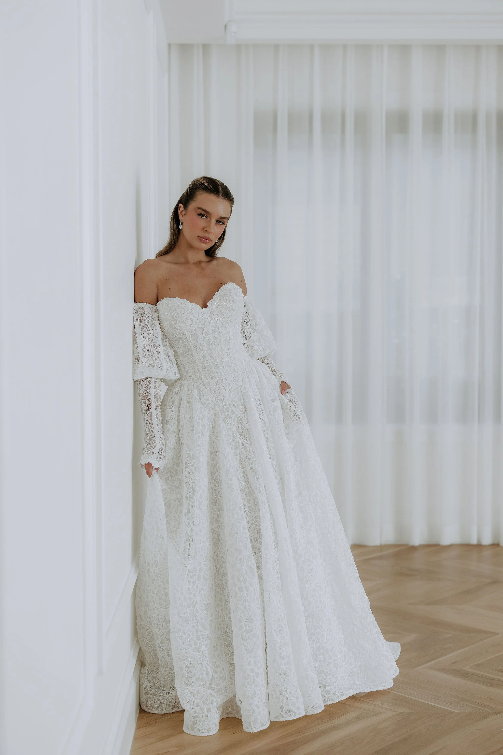 Kell Lin's Lottie dress. Full lace ball gown with lace sleeves. Modern Strapless wedding dress.