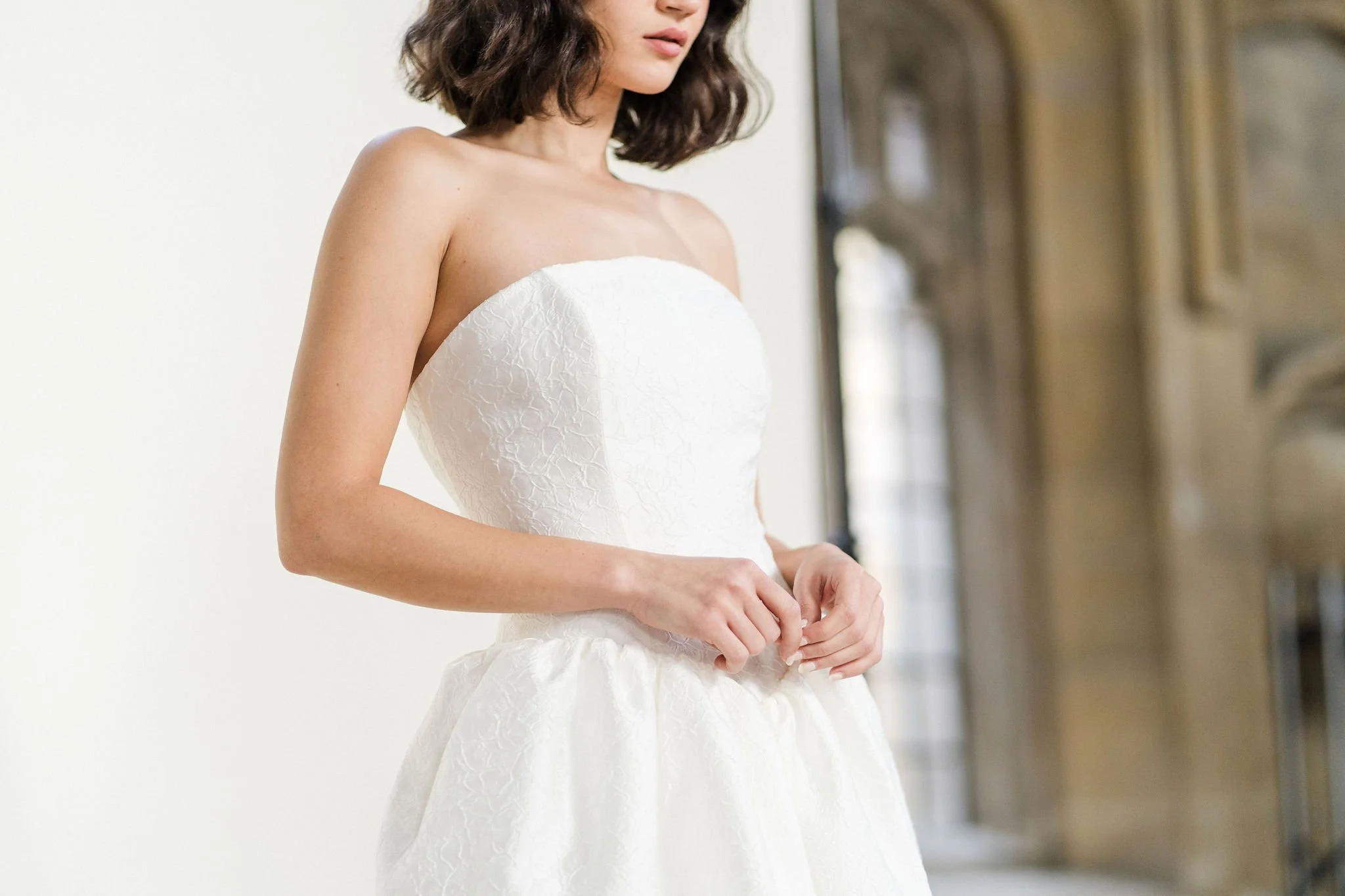 Titania Dress by Rolling in Roses – contemporary bridal gown inspired by Shakespeare's era, featuring a dropped waistline, sculptural tulip-shaped skirt with hidden pockets, and traditional corsetry techniques using high-quality sprung boning, crafte