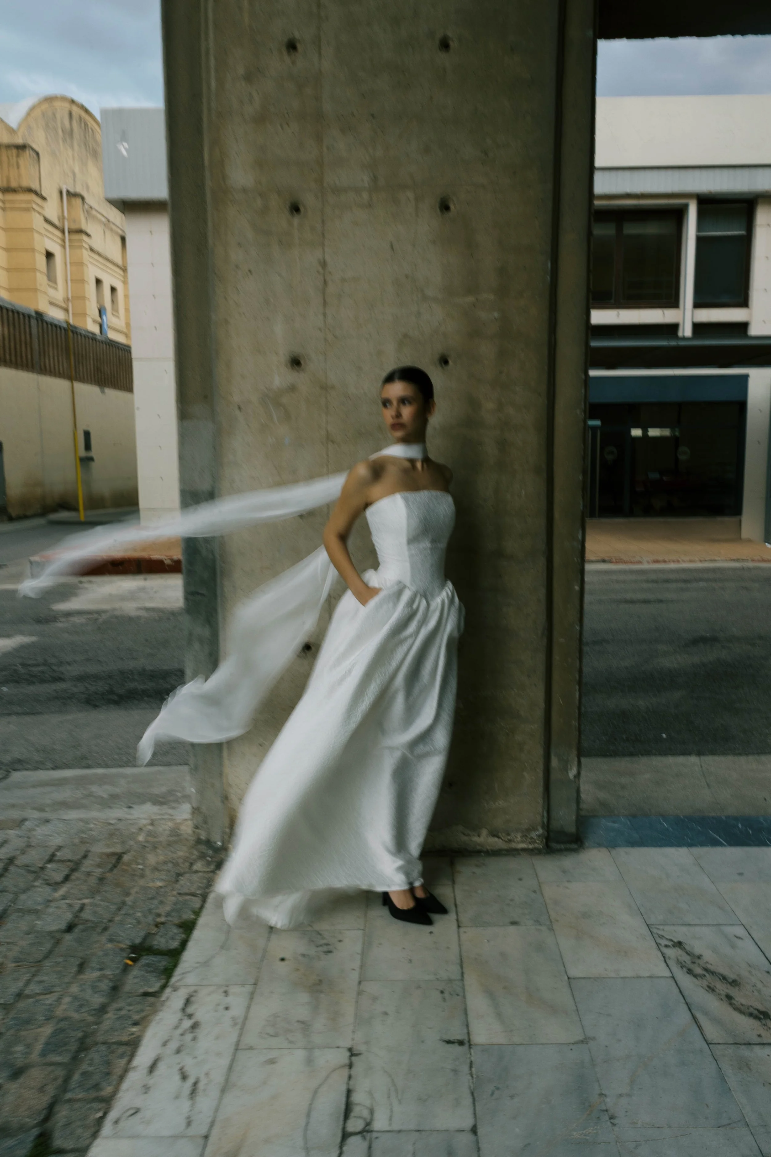 Titania Dress by Rolling in Roses – contemporary bridal gown inspired by Shakespeare's era, featuring a dropped waistline, sculptural tulip-shaped skirt with hidden pockets, and traditional corsetry techniques using high-quality sprung boning, crafte