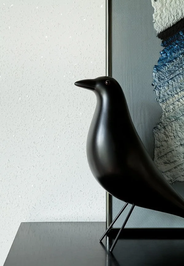 Designer interior detail vignette with sculptural bird figurine and abstract blue artwork in luxury English stucco home renovation — Montclair New Jersey