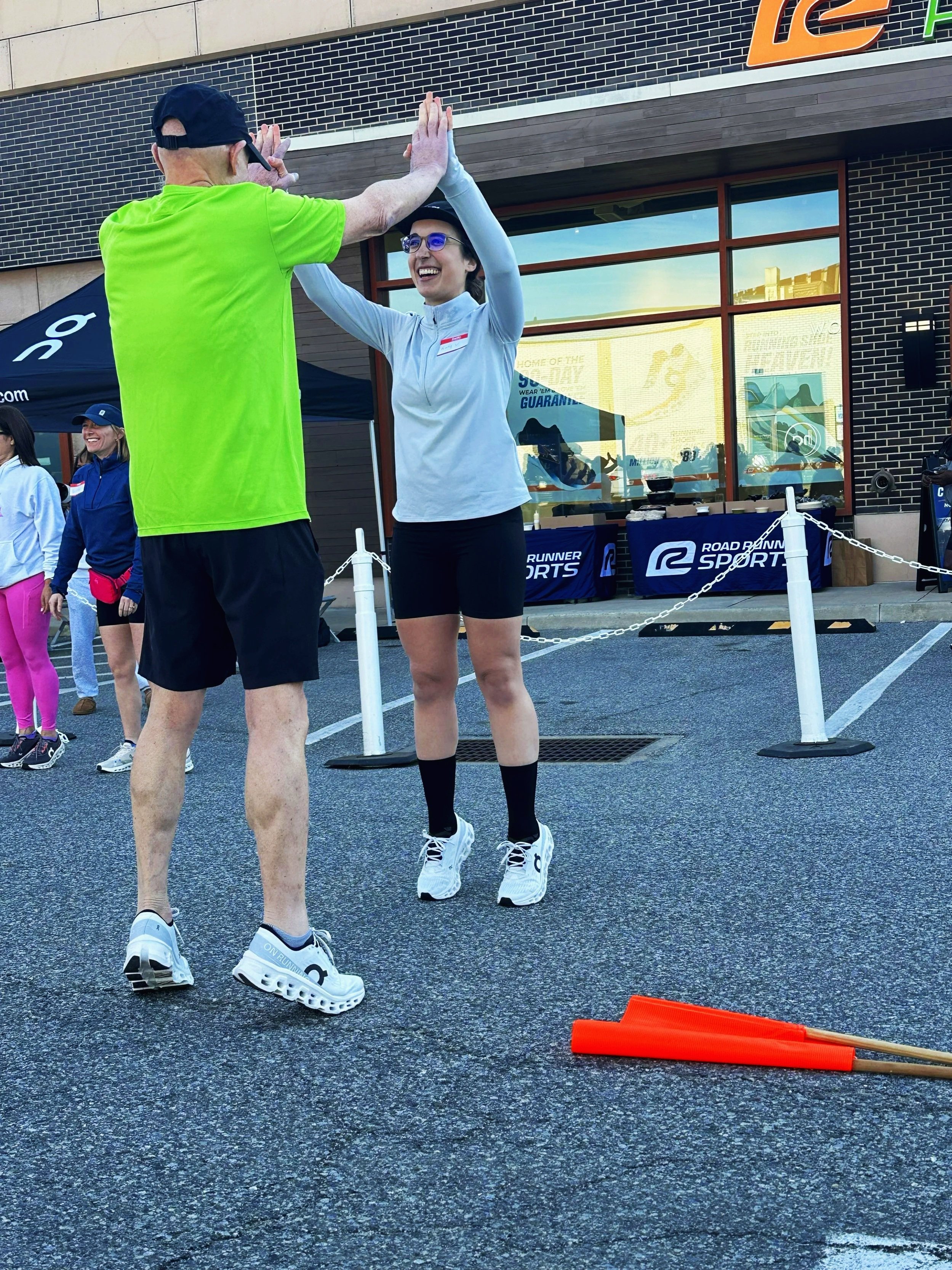 Running Physical Therapist Katy Vieira leading a warm up at RoadRunner Sports during an ON sneaker collaboration. 