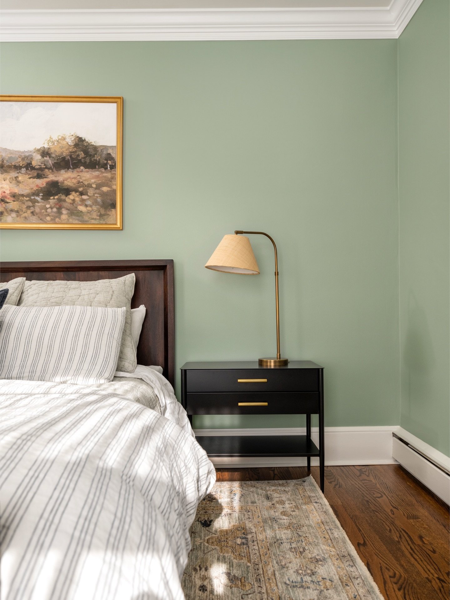Soft green walls and layered linens set a calm, welcoming tone from the moment you walk in. Thoughtful details make it easy for guests to slow down, settle in, and feel at home 🌿

Design: @colorandcrownid 
Photography: @ommediallc