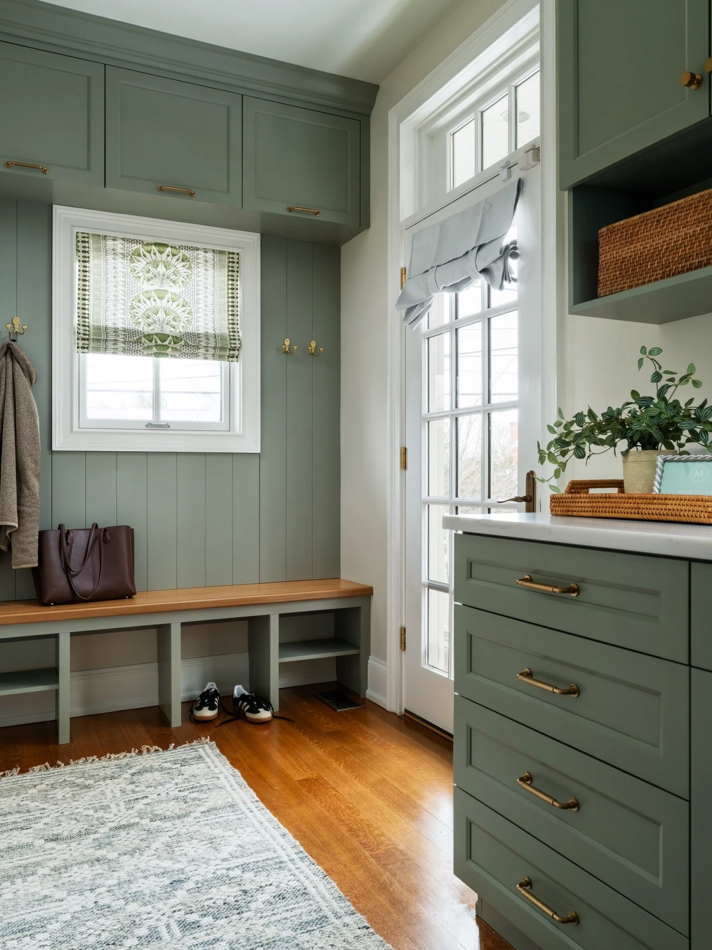 A mudroom should be more than storage. Sage paneling and custom hardware turn this functional entry into a high-end transition point. 🌿

Design: @colorandcrownid 
Photography: @ommediallc 
Cabinetry: @wagnerswoodspecialties