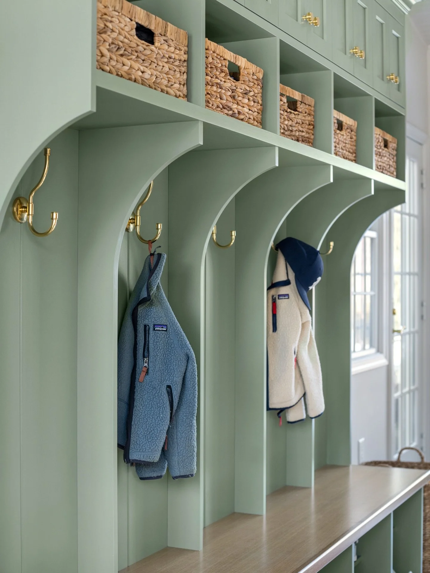 A mudroom is often one of the most used areas in a home. Thoughtful details like arched cabinetry and warm brass accents turn a hardworking entry into a space that feels just as considered as the rest of the house 🌿

Design: @colorandcrownid 
Cabine