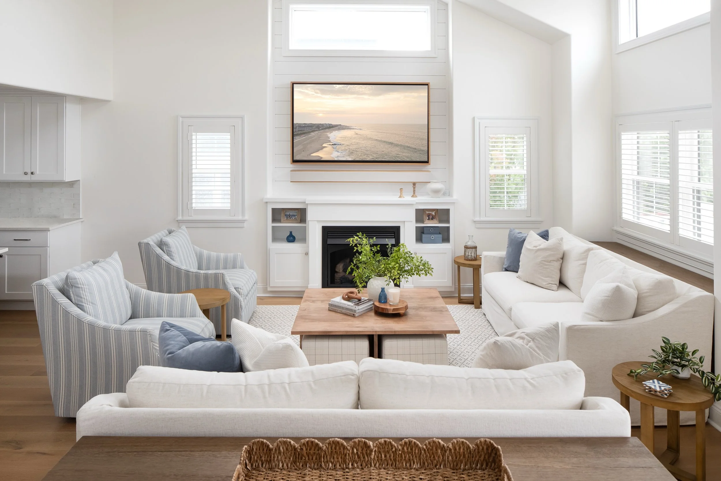 A room this open could easily feel cold or disconnected &mdash; but it doesn&rsquo;t. That&rsquo;s intentional. Scale and proportion do the quiet work: generous sofas, a rug that anchors the seating, a fireplace tall enough to hold its own against th