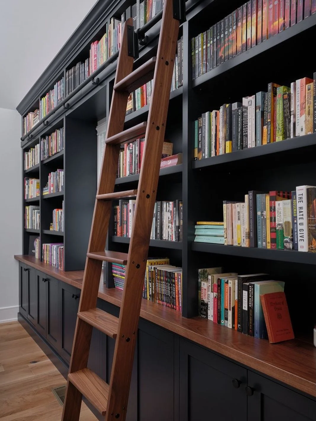 The best design starts with the question: what do you love? For this client, it was books. So we made them part of the architecture &mdash; built-ins, library ladder, and all.

Design: @colorandcrownid 
Builder: @jrmaxwellbuilders