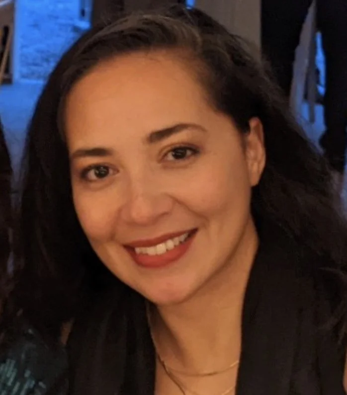 Close-up of a smiling woman (Erika) with dark brown hair