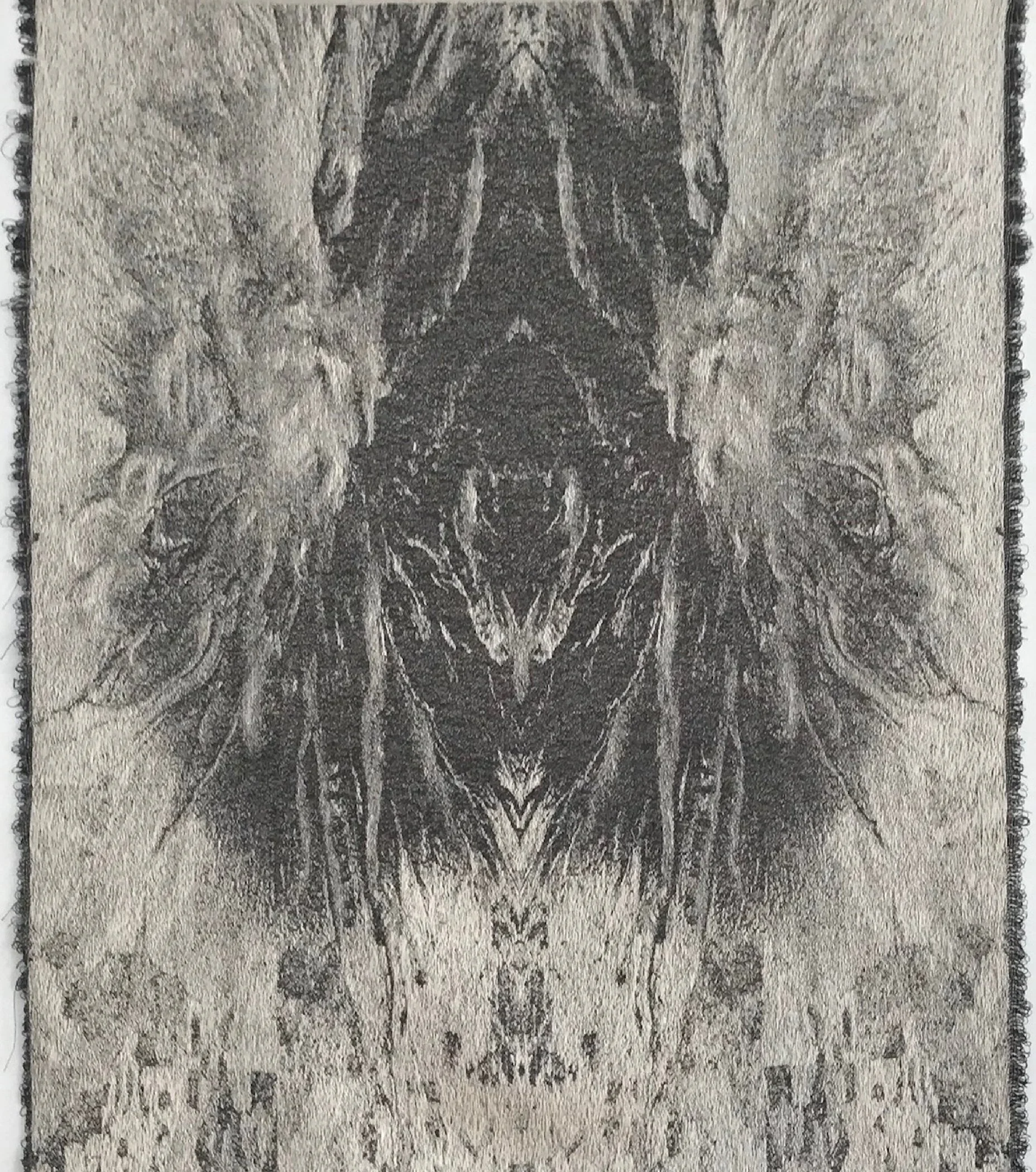 A symmetrical black and white abstract design resembling a tree with branches, roots, and a face-like shape in the center, printed on textured paper.