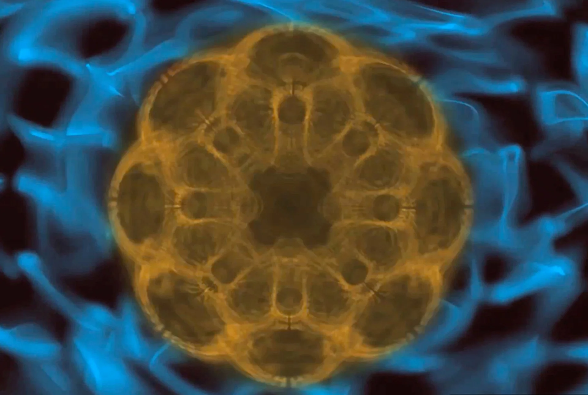 Close-up of a circular metal structure with glowing blue and yellow colors, resembling a high-tech or sci-fi device or portal.