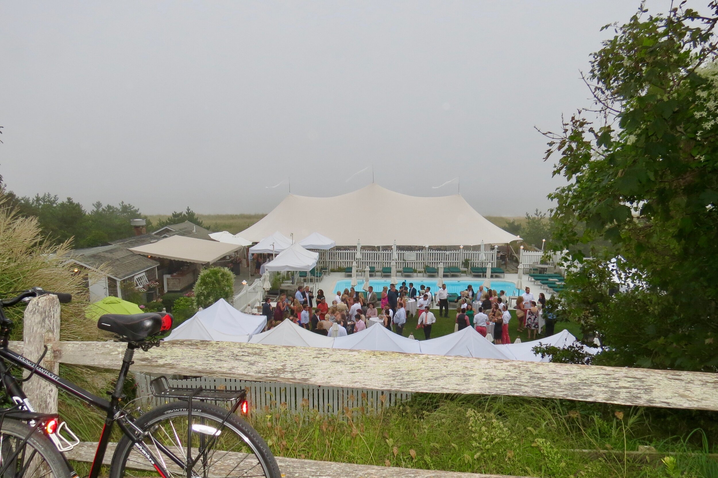 A wedding party in progress at a venue with a swimming pool