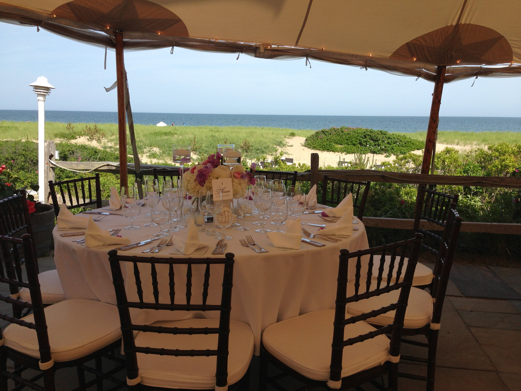 A wedding reception table at a venue overlooking the beach