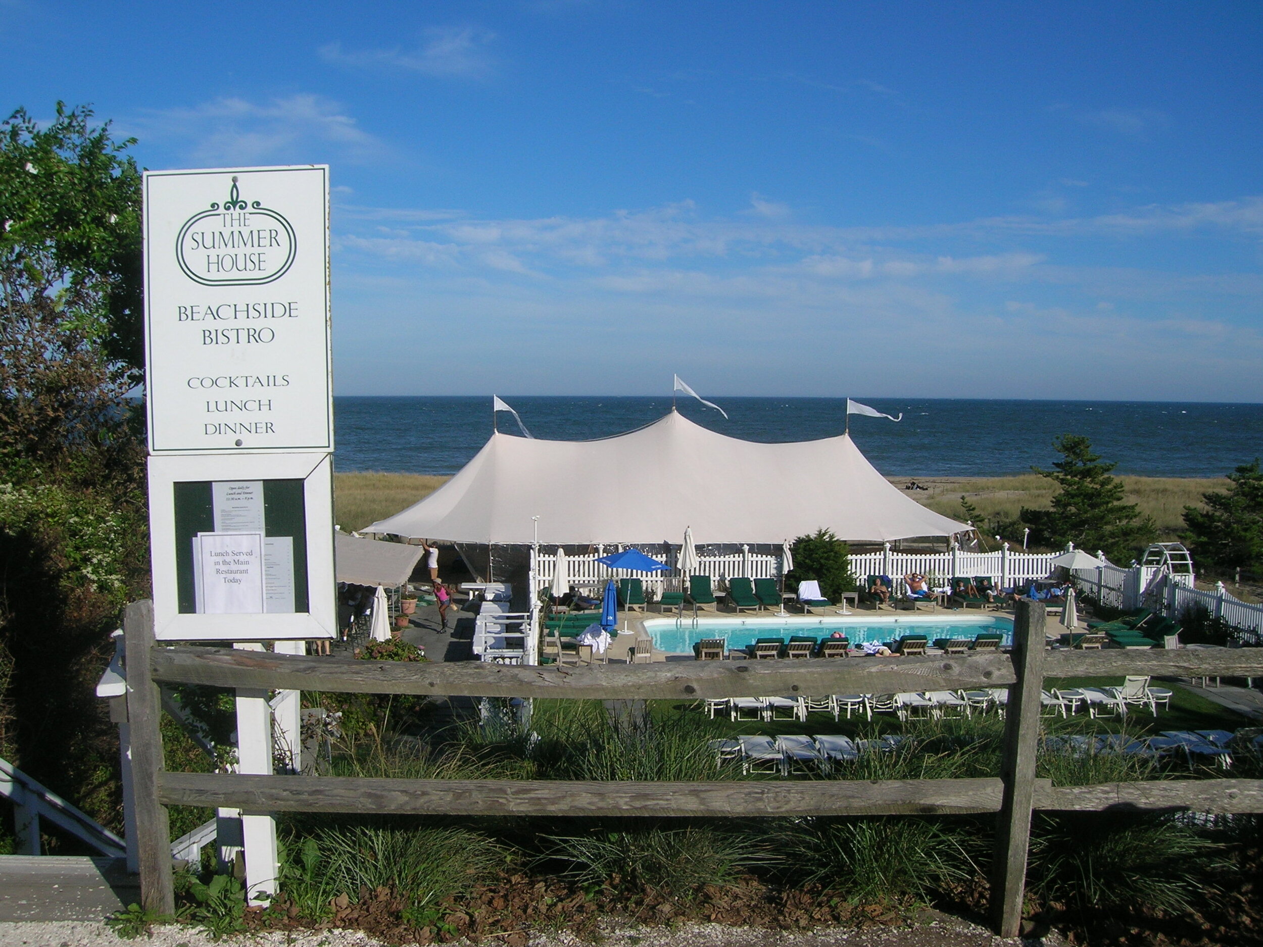 A large tent structure setup for wedding near ocean