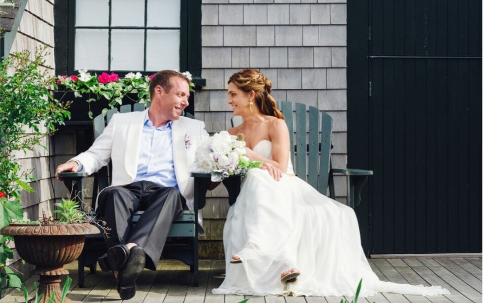A bride and groom posing for wedding photos outdoors