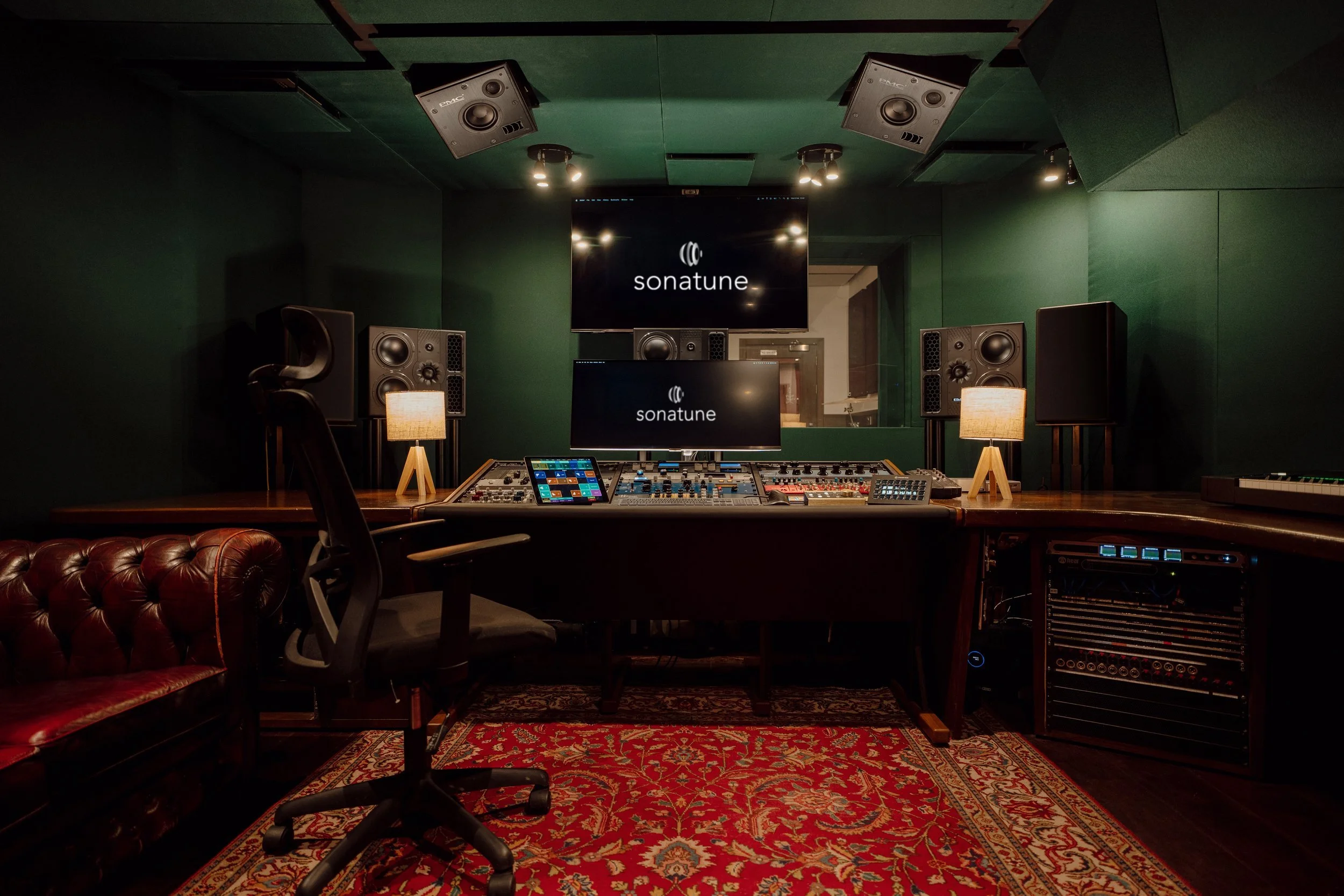 Sonatune, Nottingham -  recording studio with , PMC ATMOS speakers, a mixing console, a keyboard, two monitors displaying. DAD AX Centre 