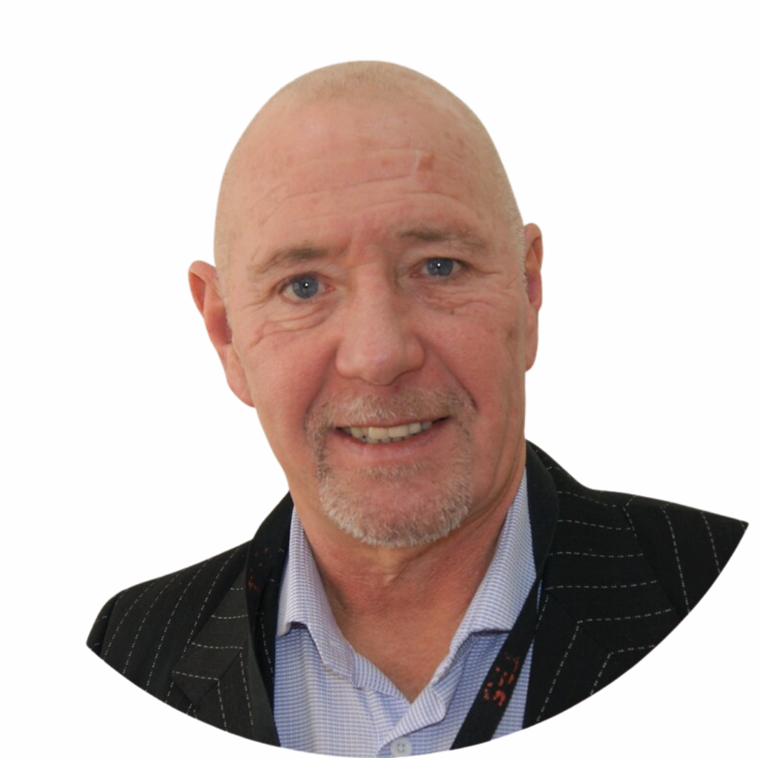 Portrait of an older man with a bald head, blue eyes, and a goatee, wearing a black pinstripe suit and a light blue collared shirt.