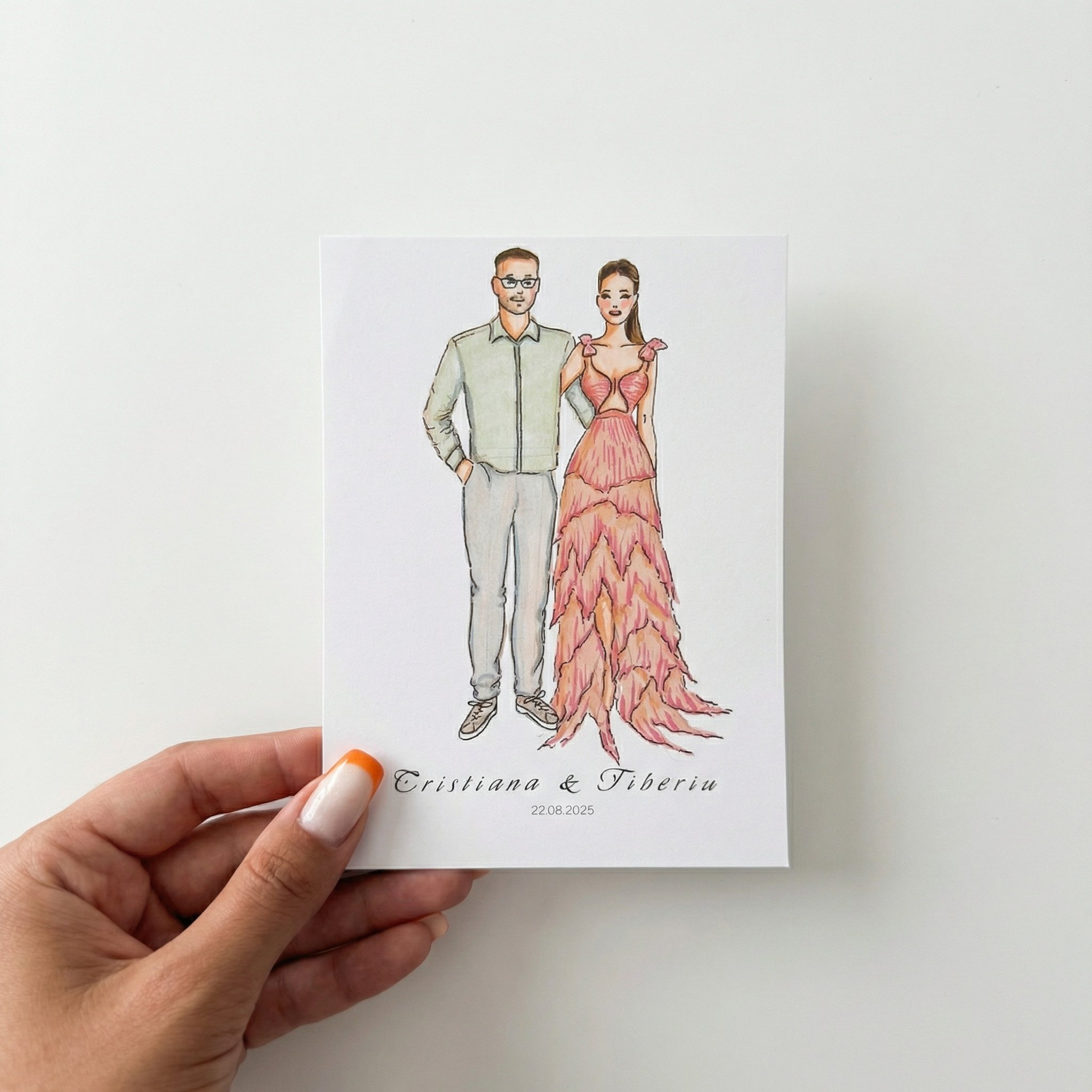 Hand holding a wedding invitation featuring a watercolor illustration of a couple in formal attire, with the names 'Cristiana & Tiberiu' and the date '22.08.2025' at the bottom.