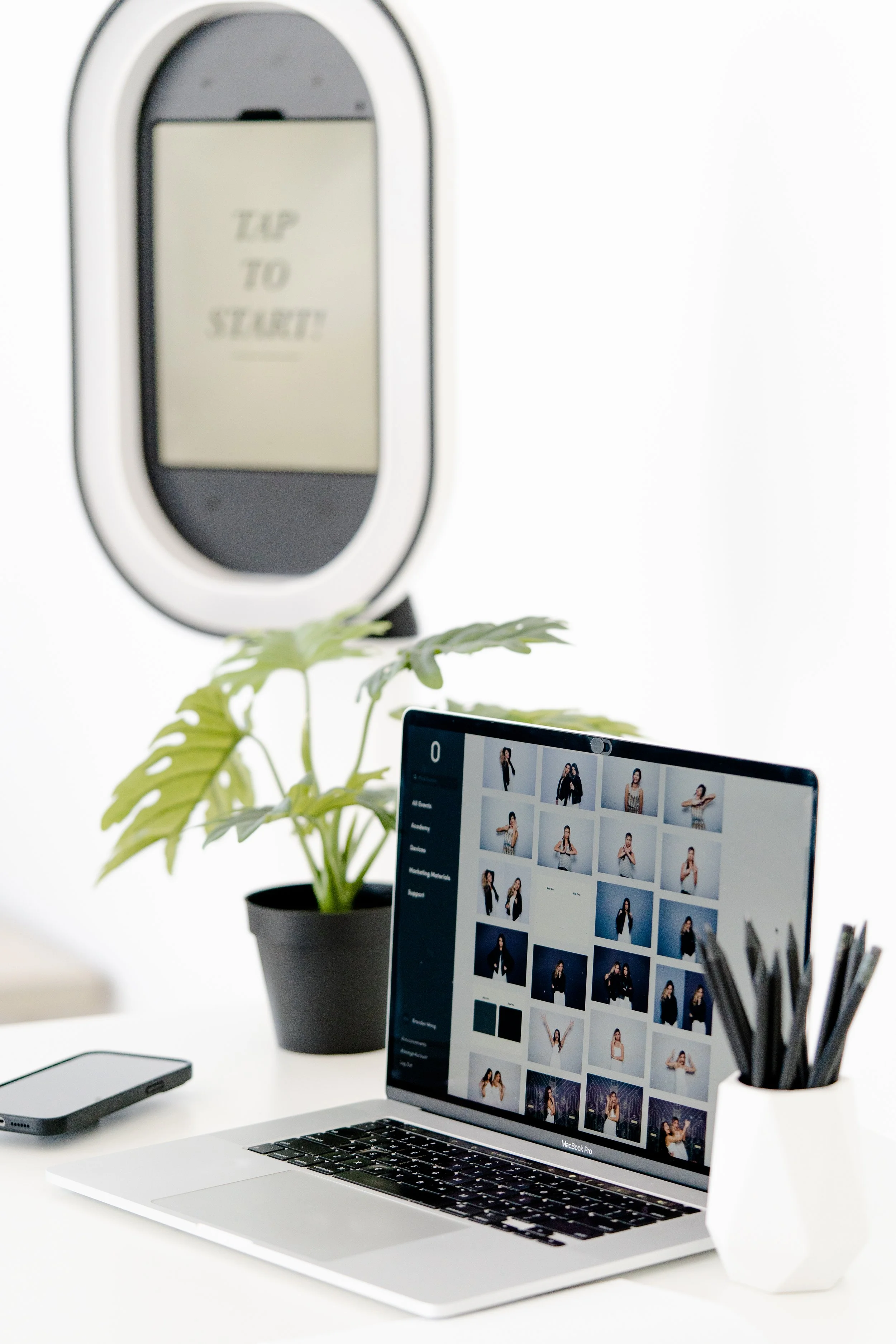 Professional photographer and photo booth setup at event comparing coverage options