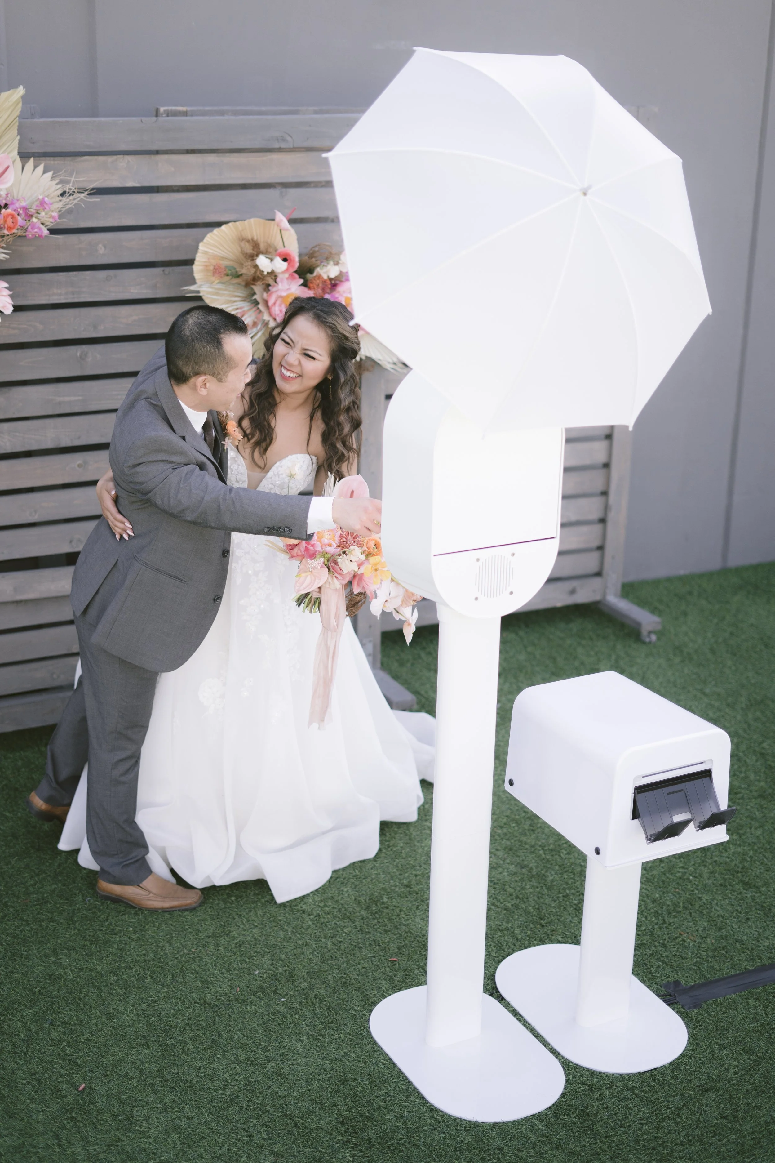 Bride and groom at elegant wedding photo booth experience