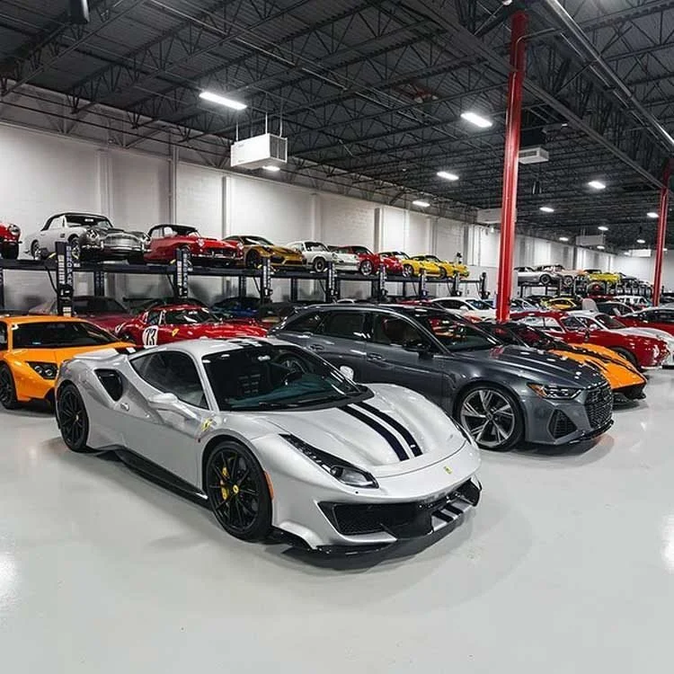Indoor showroom with luxury cars including a white Ferrari on a high-gloss epoxy-coated floor.