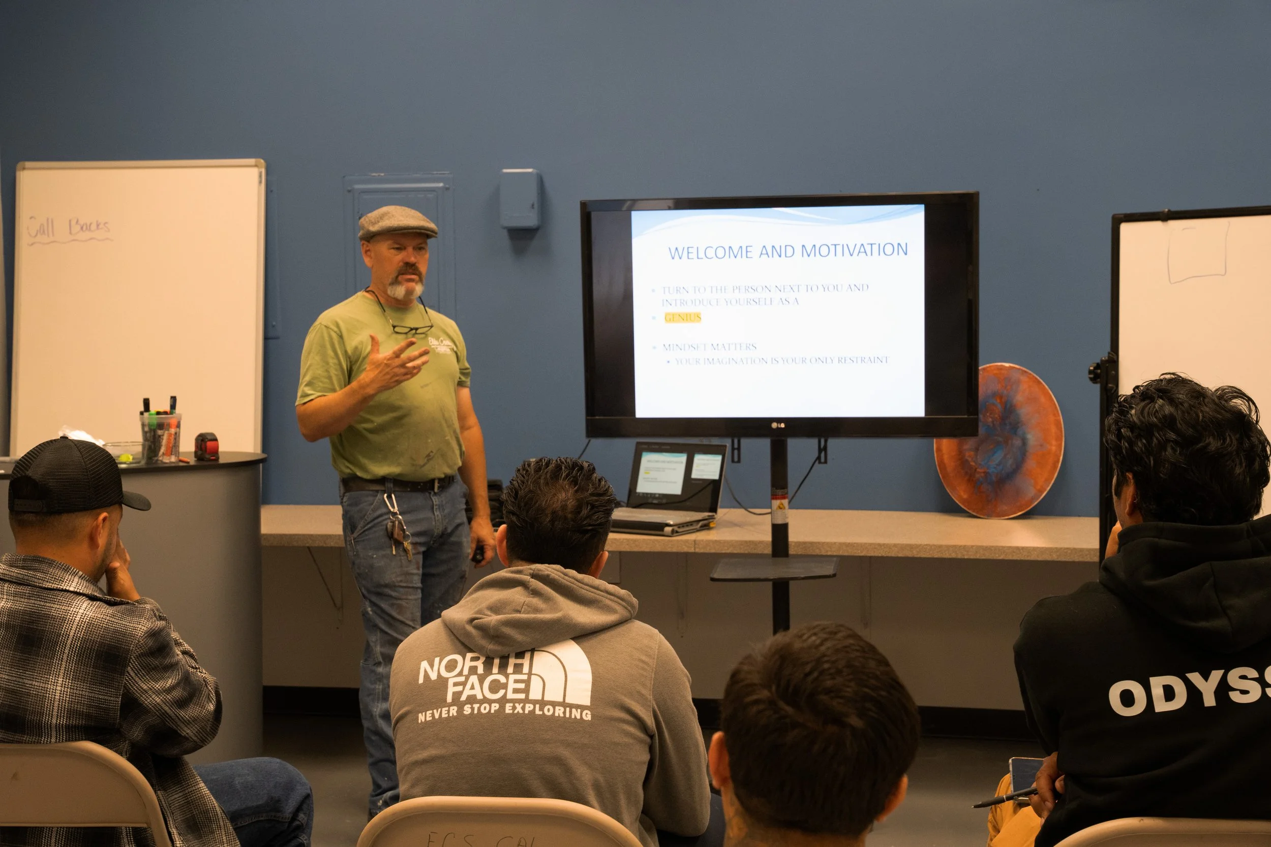 Professional epoxy class and training: An instructor in a green shirt gives a motivational presentation to students at an Elite Crete certification workshop in California.