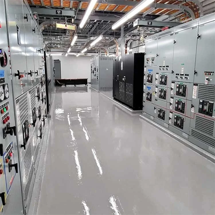 Industrial control room with metal electrical panels and a polished gray ESD floor under fluorescent lighting.