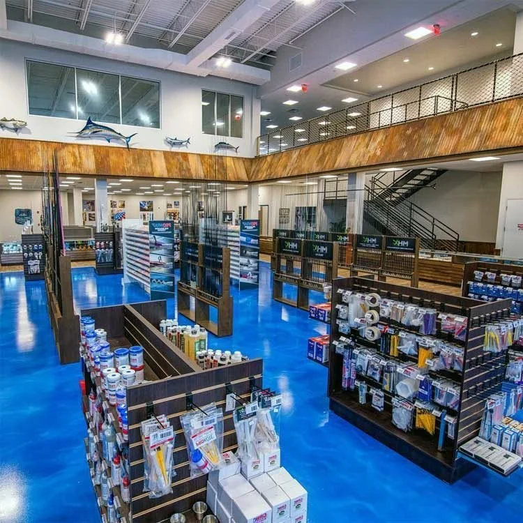 Retail supply store interior with stocked shelves, decorative fish wall art and a blue metallic reflector epoxy floor.