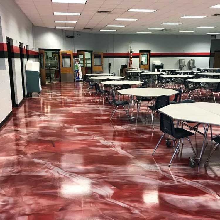 School cafeteria with hexagonal tables and a shiny red marble-like reflector epoxy floor.