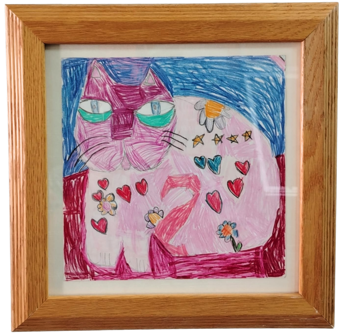 Colorful drawing of a cat with pink and white fur, green eyes, surrounded by hearts, flowers, and stars in a wooden frame.