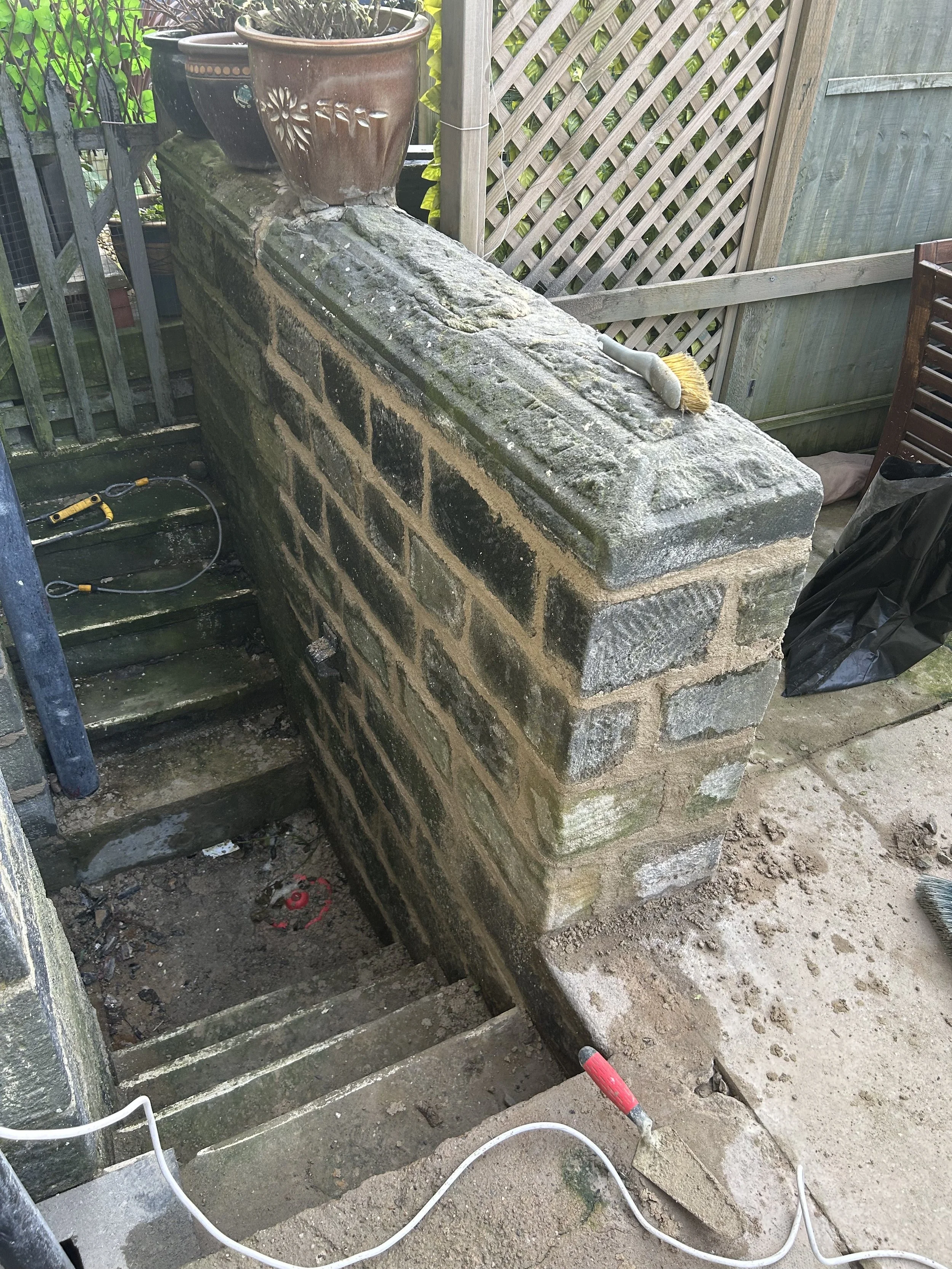 A sand stone wall raked out and re-pointed with lime mortar for a textured effect.