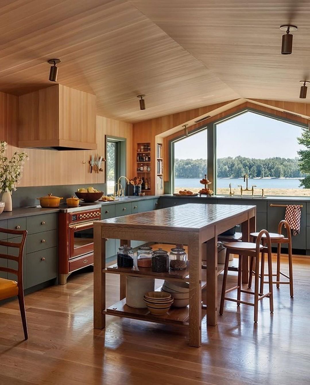 Typically, range hoods are concealed using faux cabinets. But what if you choose not to have hanging cabinets? Here, the beautiful windows are the star of the show and having a modern range hood would draw the eye elsewhere. The decision to keep it s
