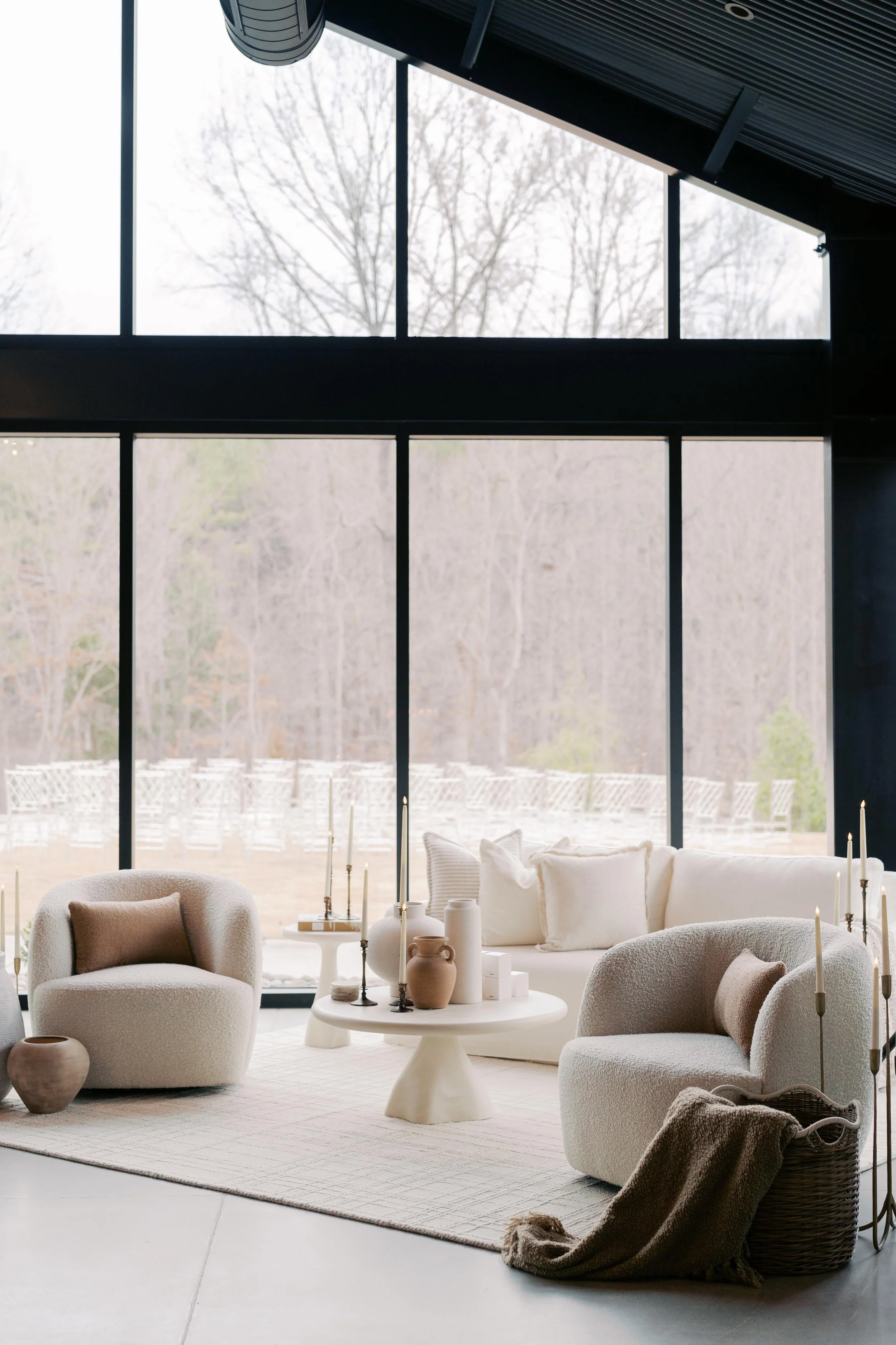 modern interior wedding lounge setup with rounded furniture and candles