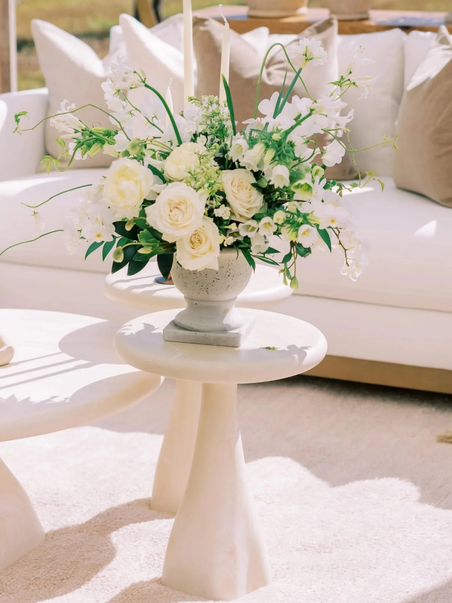 trio of minimalist coffee tables with floral arrangement on top