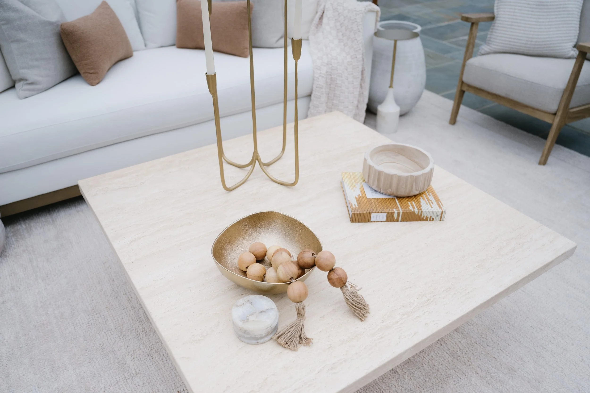 styled coffee table with candles, a book, and bowls