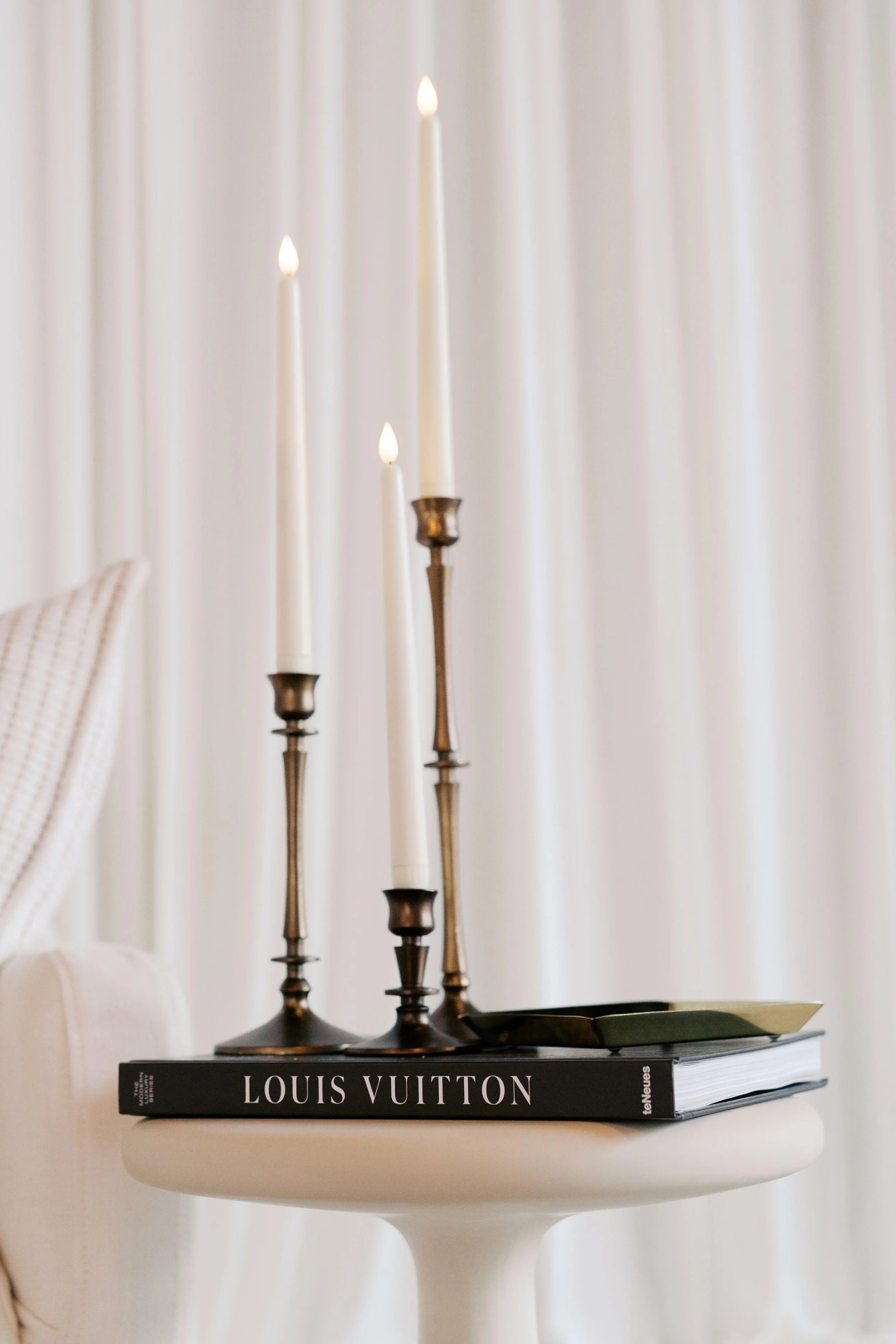 end table styling with candlesticks on Louis Vuitton coffee table book