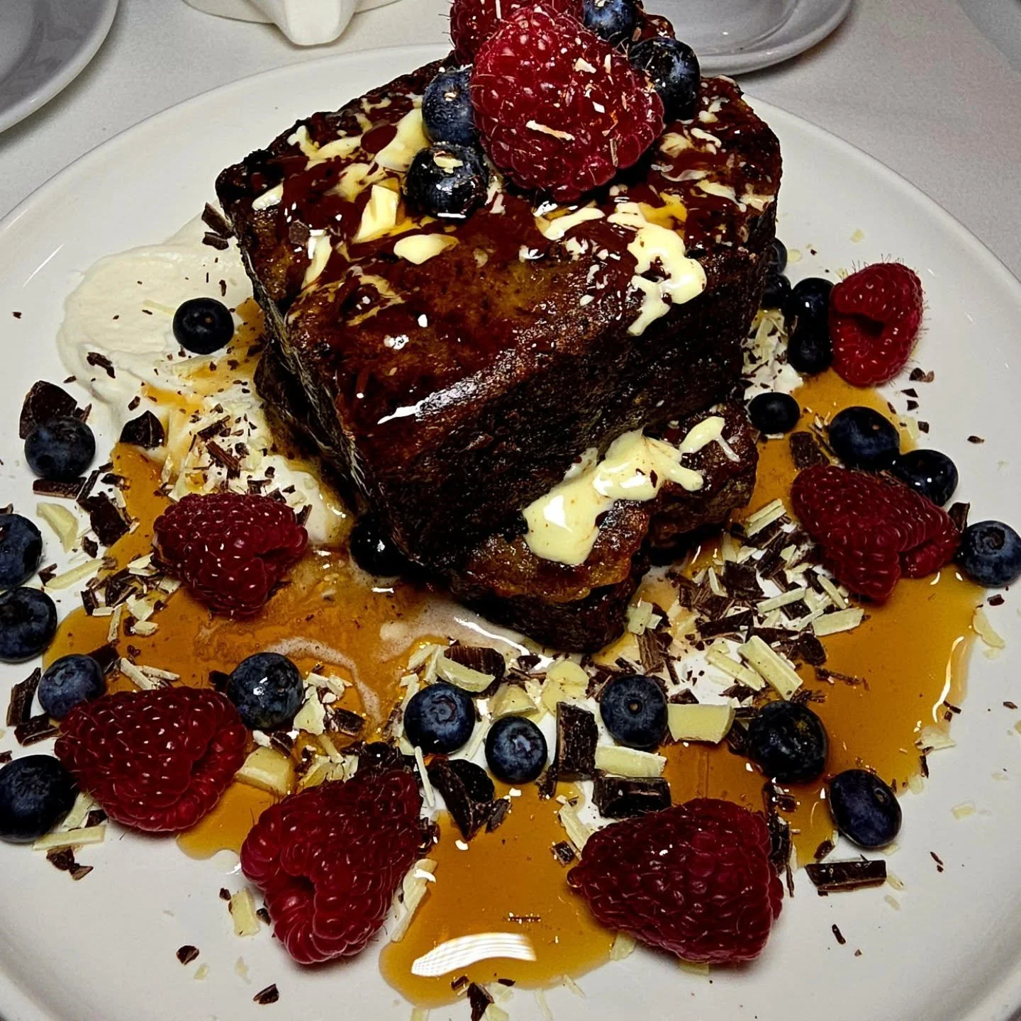 Banana Bread French Toast, black &amp; white chocolate shavings, fresh berries &amp; a collision course of maple syrup.
