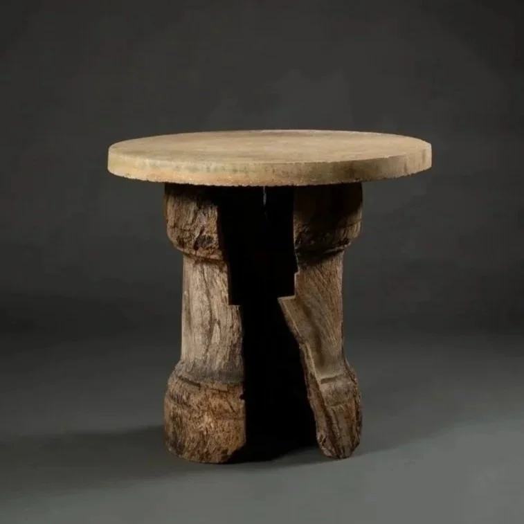 ROUND STONE TABLE ON WOODEN BENCH