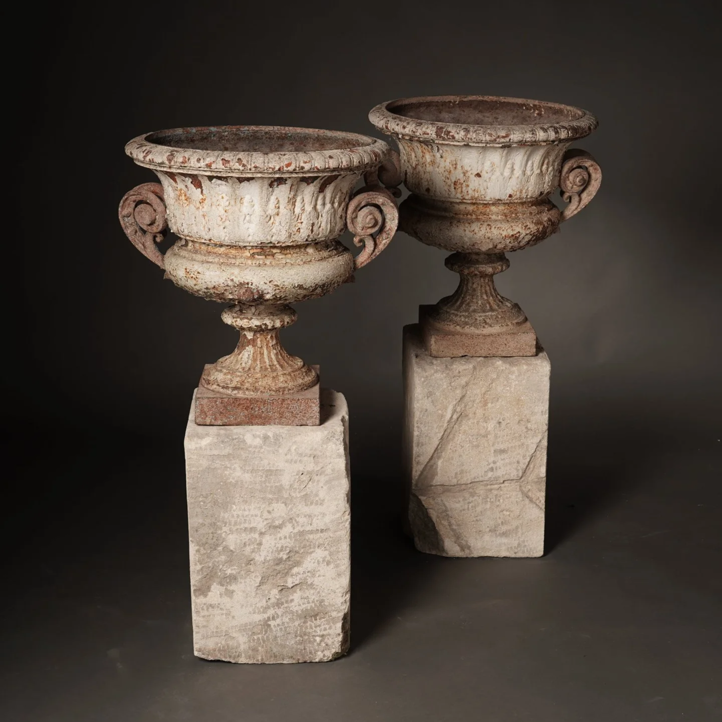 CAST IRON URN ON STONE PLINTH