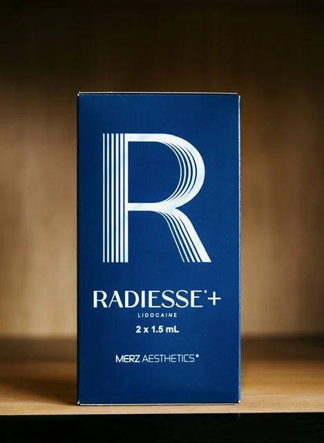 Blue box of Radisse+ Lidocaine product on wooden surface.